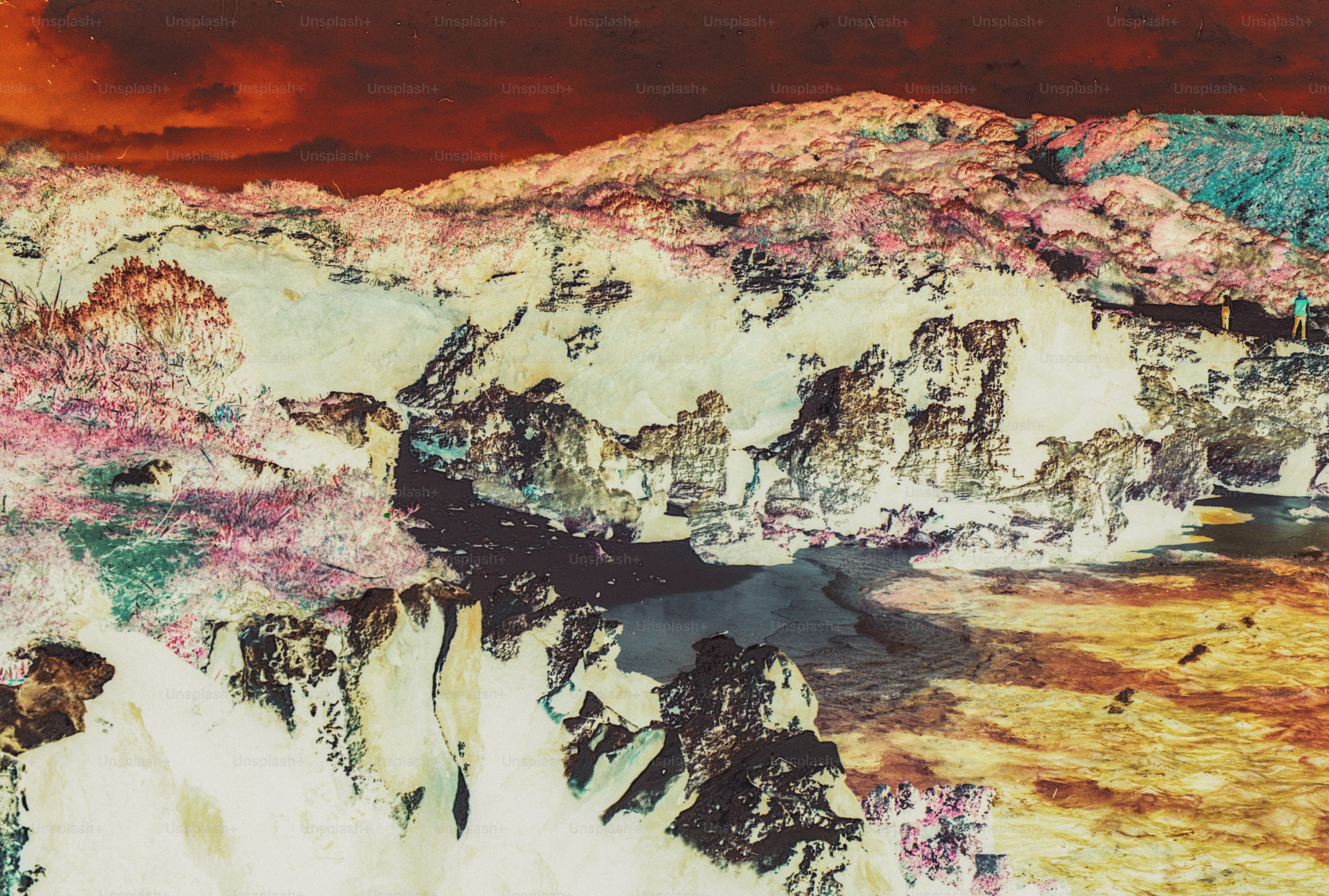 A rocky coastline with inverted colors and a person walking along the cliff