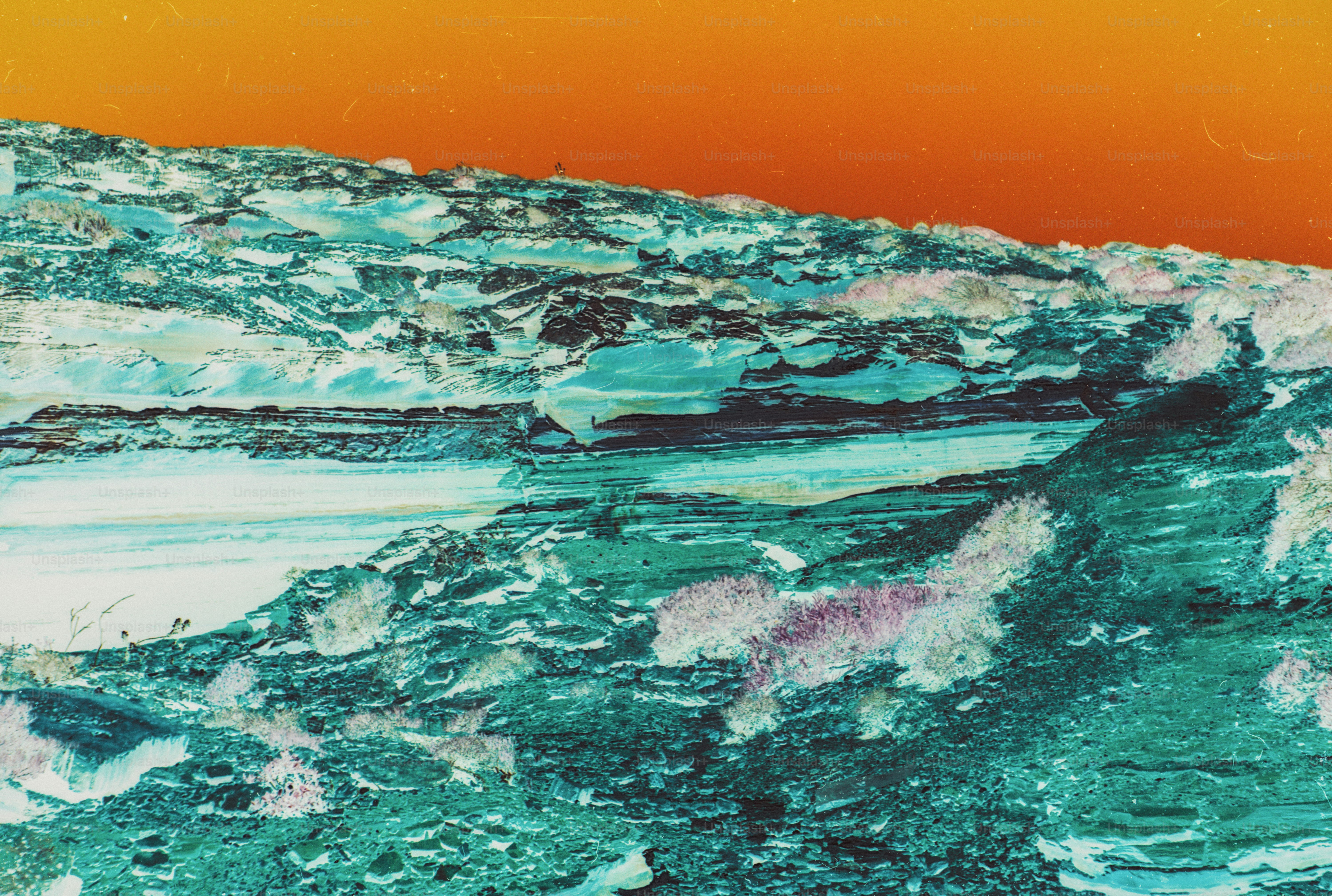 A rocky landscape with teal textures against a vibrant orange sky
