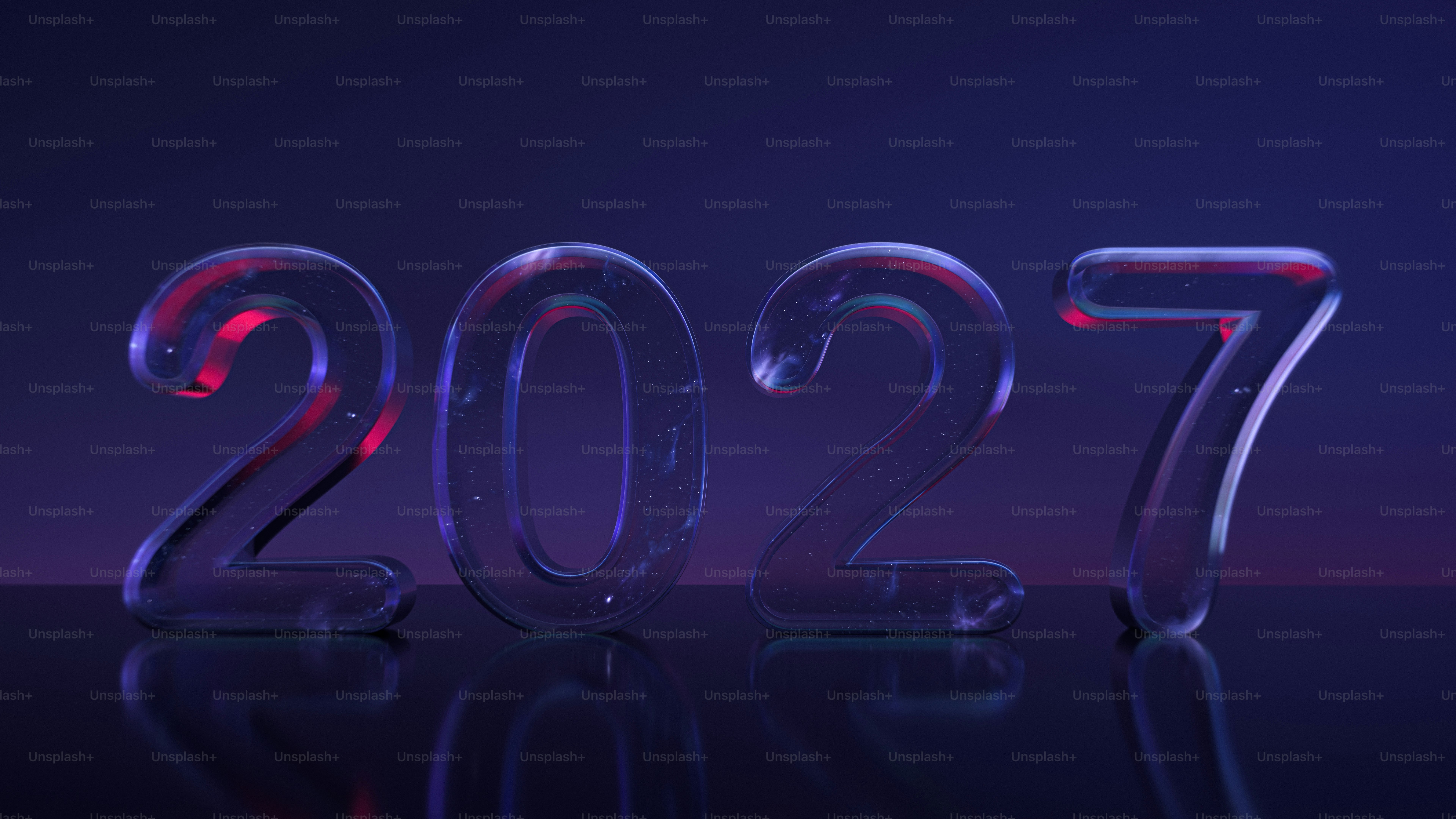 The numbers 2027 in translucent glass with a dark nebula interior on a reflective surface