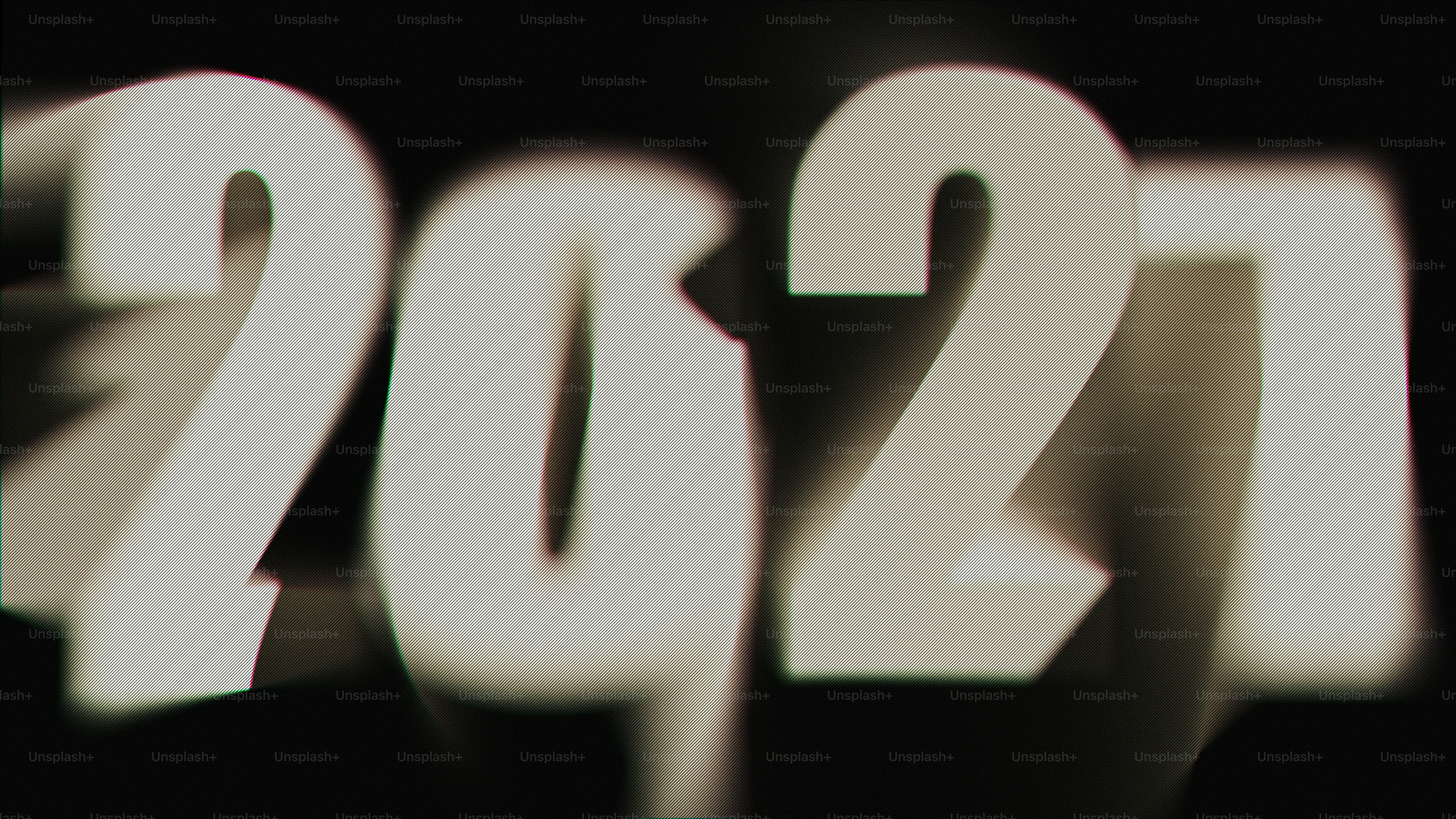 The numbers 2027 in a blurred white font with chromatic aberration on black