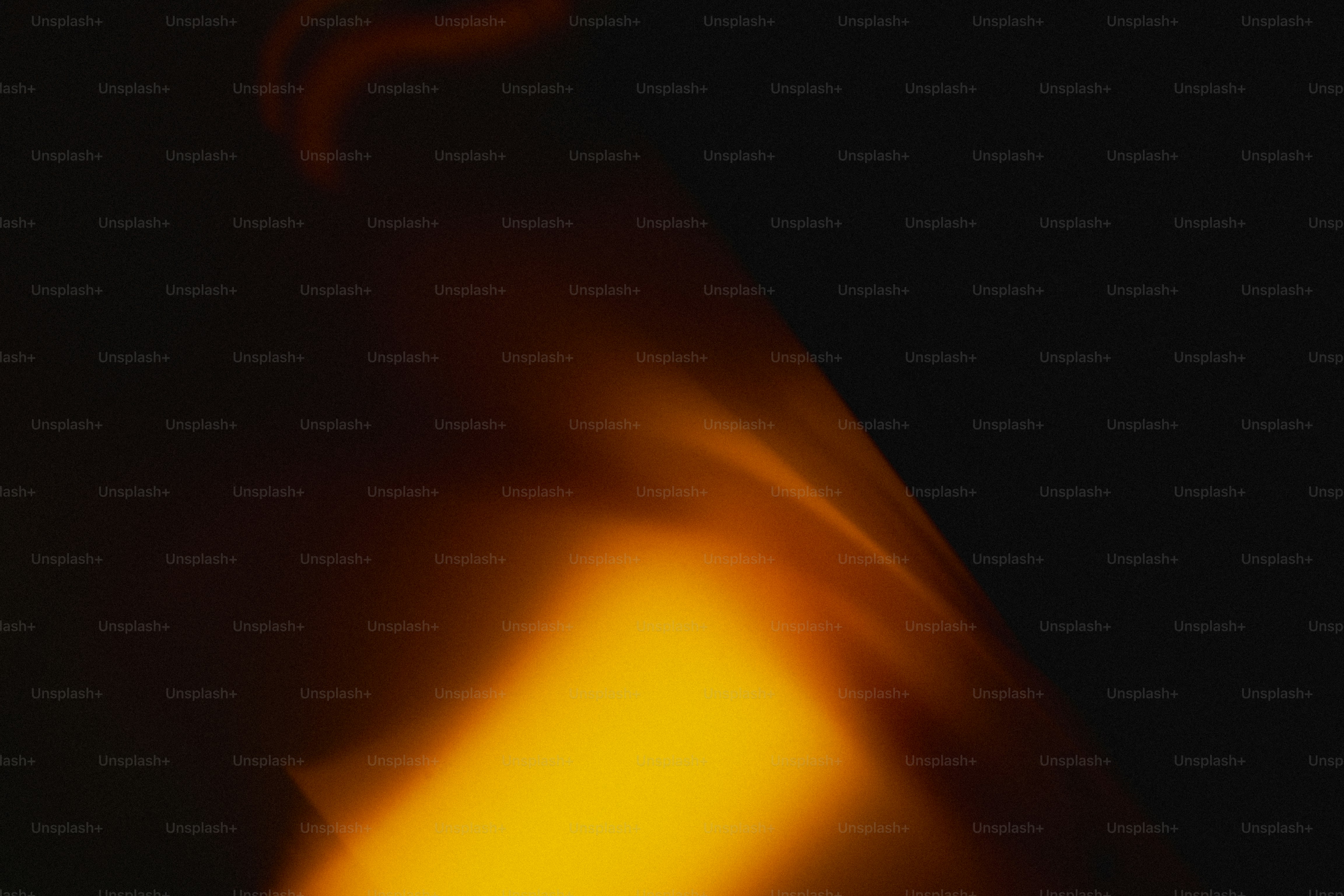 A soft beam of warm orange light against a dark background