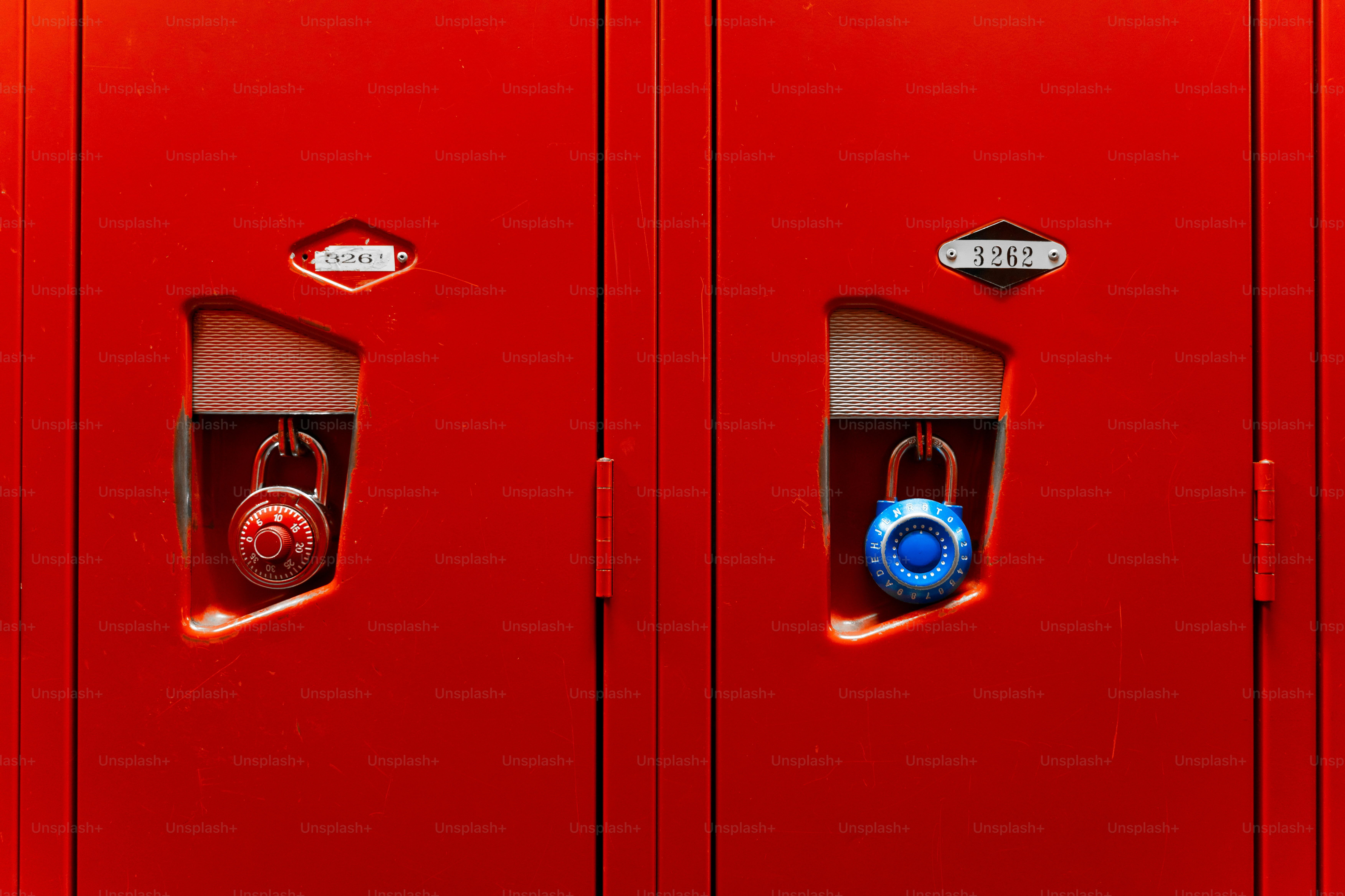 Two red metal lockers with a red and a blue combination padlock
