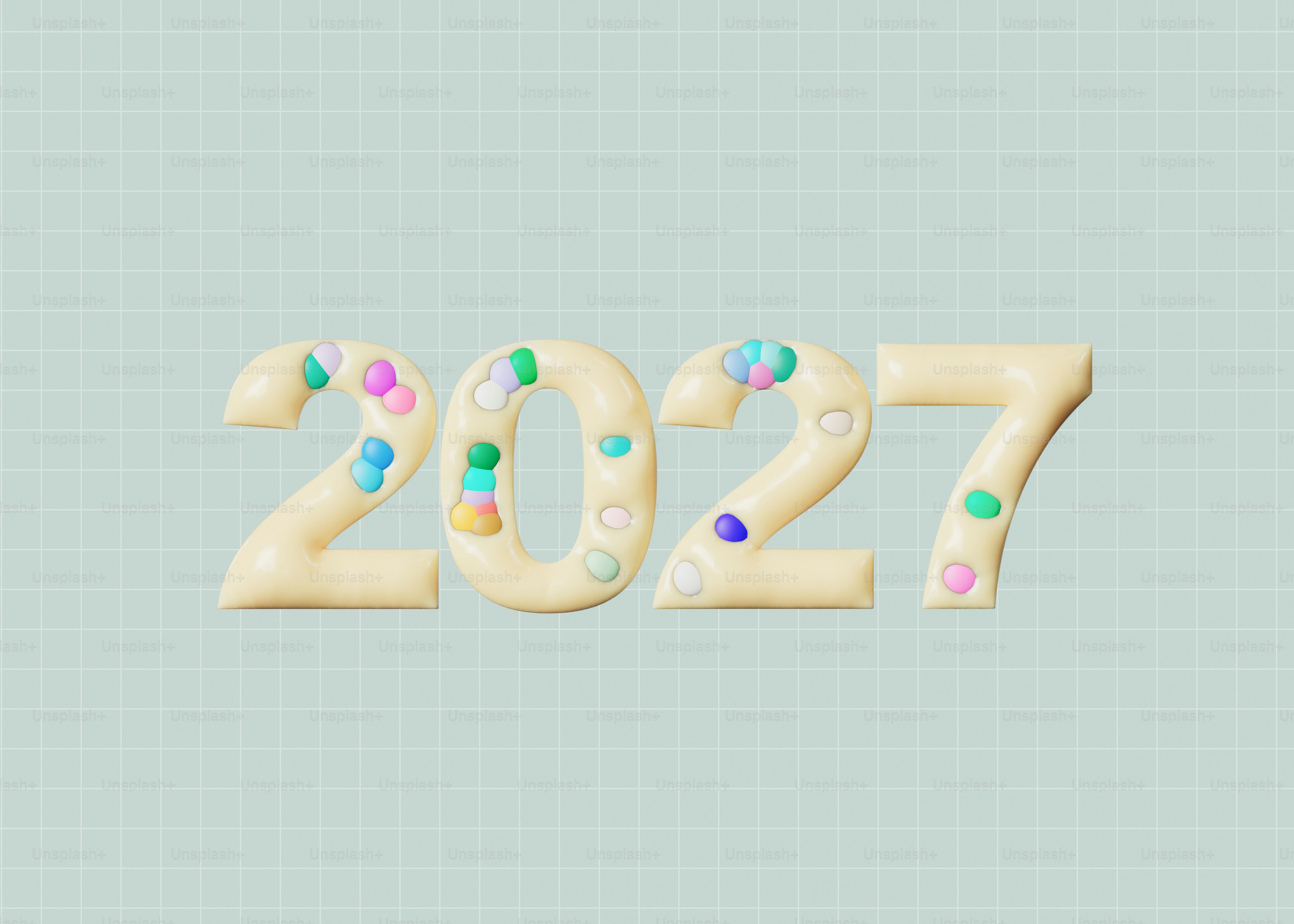The number 2027 in cream-colored 3D lettering decorated with small colorful candy spheres
