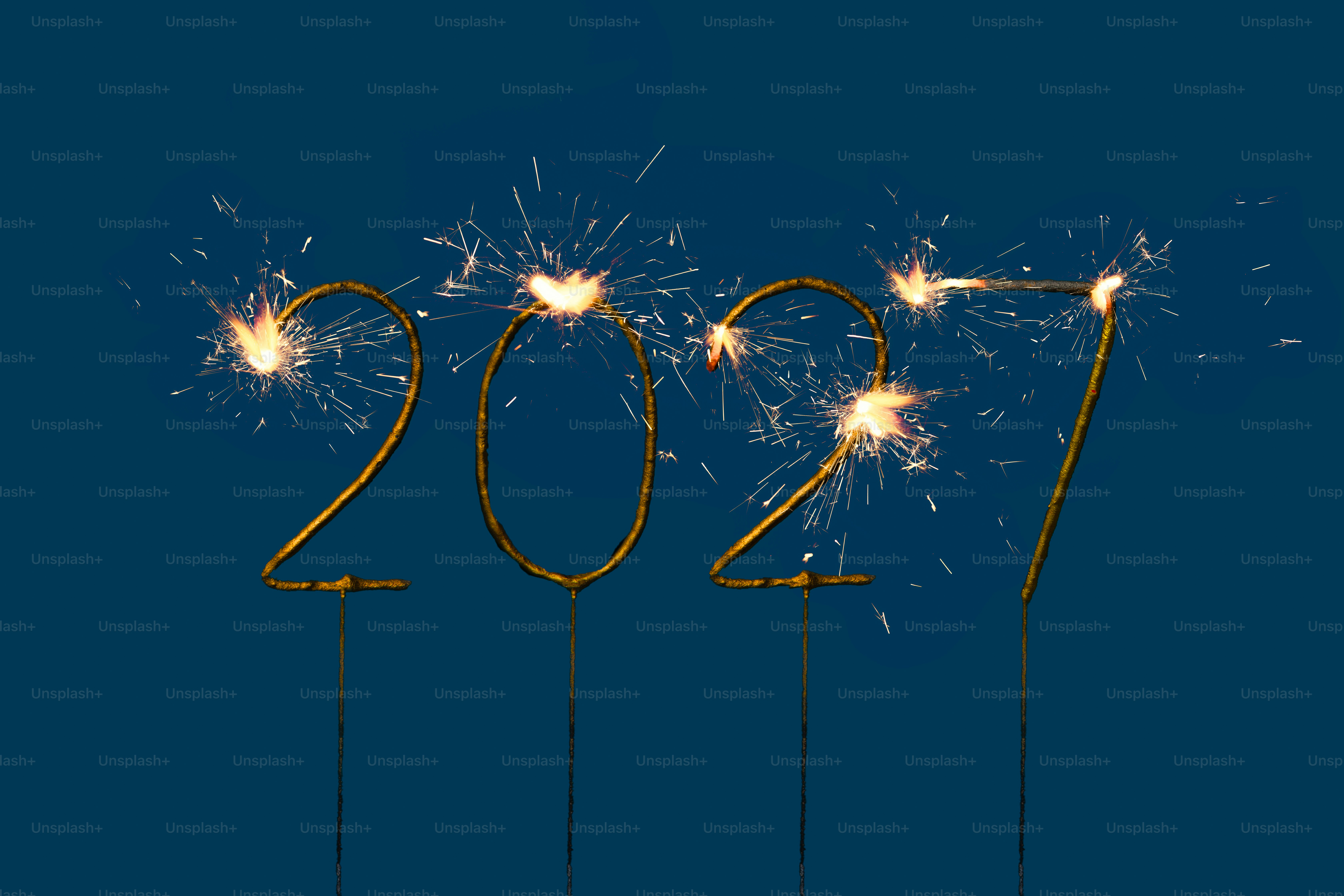 Sparkler numbers forming 2027 against a solid dark blue background