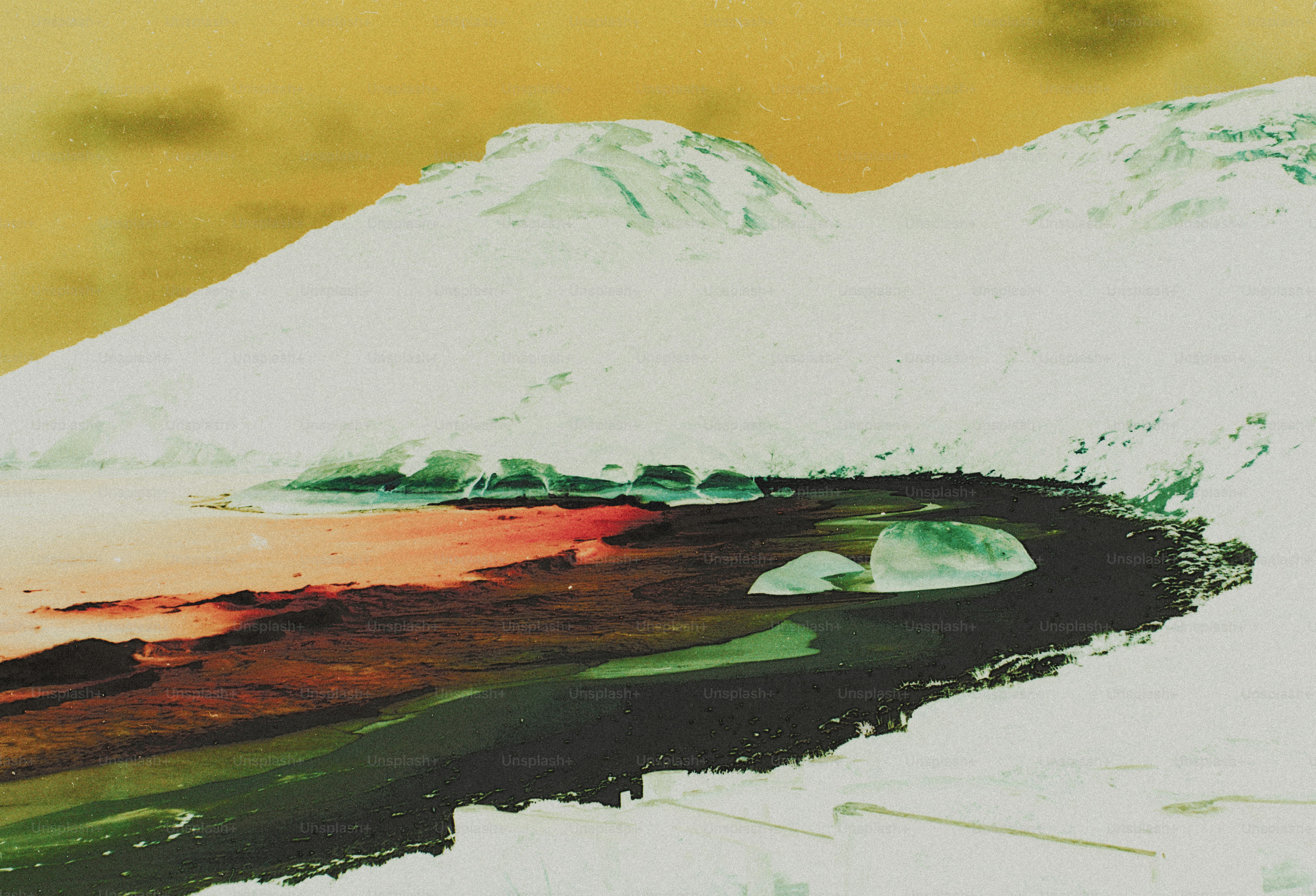 A snowy mountain slope above a dark shoreline with ice chunks