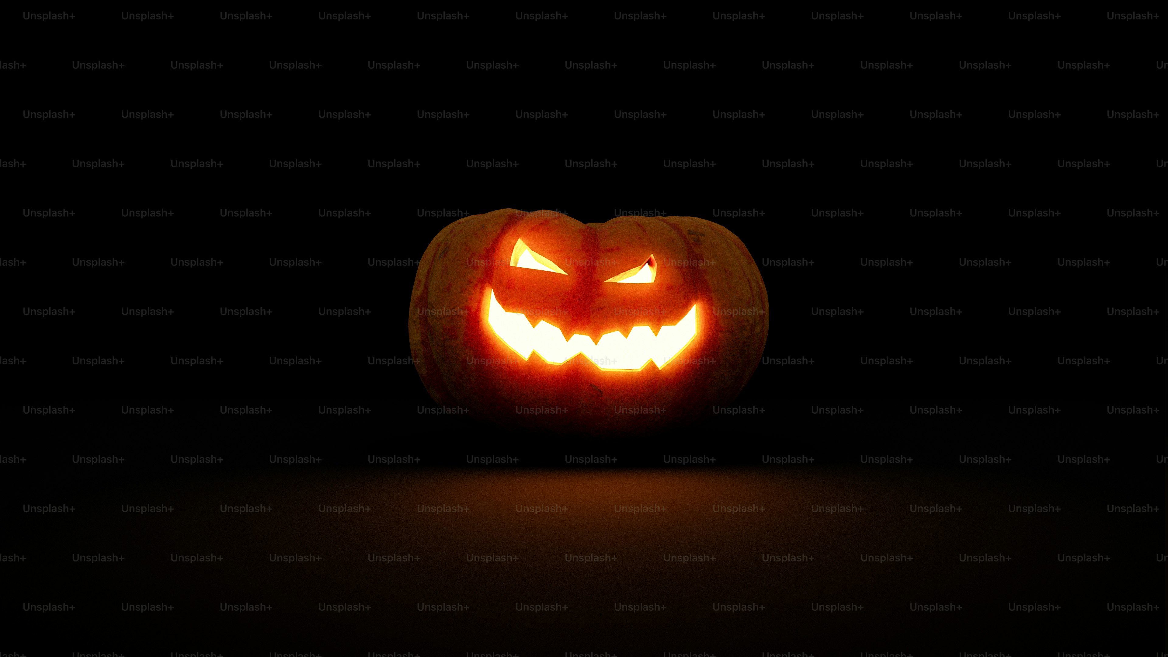 A glowing jack-o'-lantern with a carved face against a dark background
