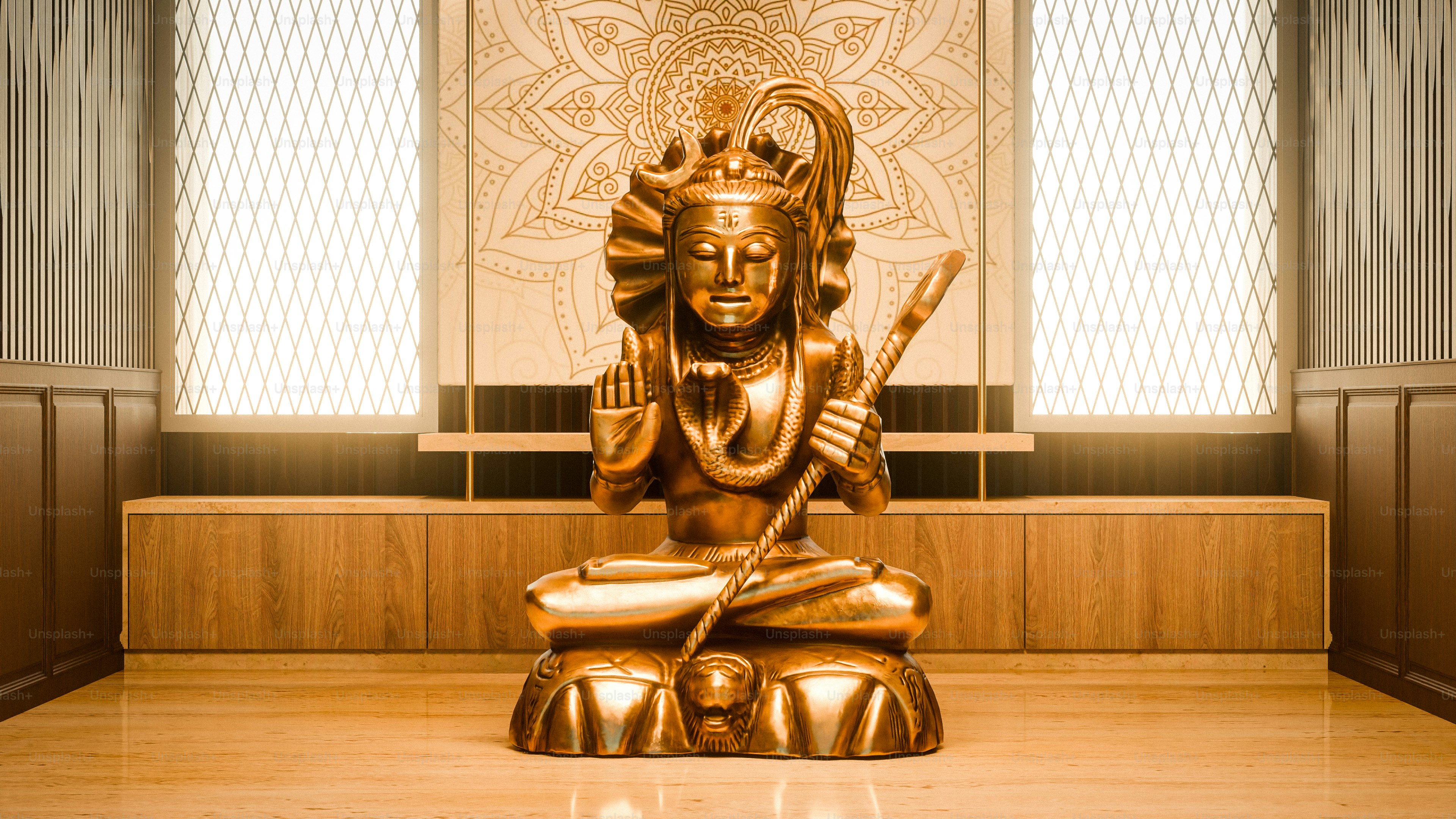 A golden statue of Shiva sitting in a meditative pose on a wooden platform