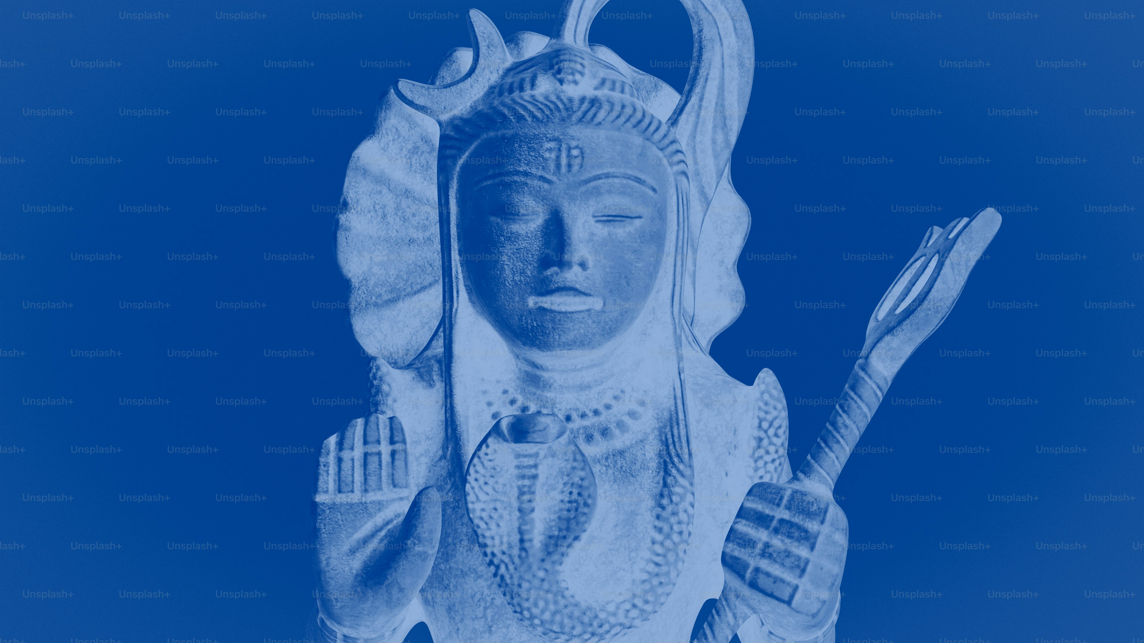 A stone statue of Shiva with a cobra on a blue background