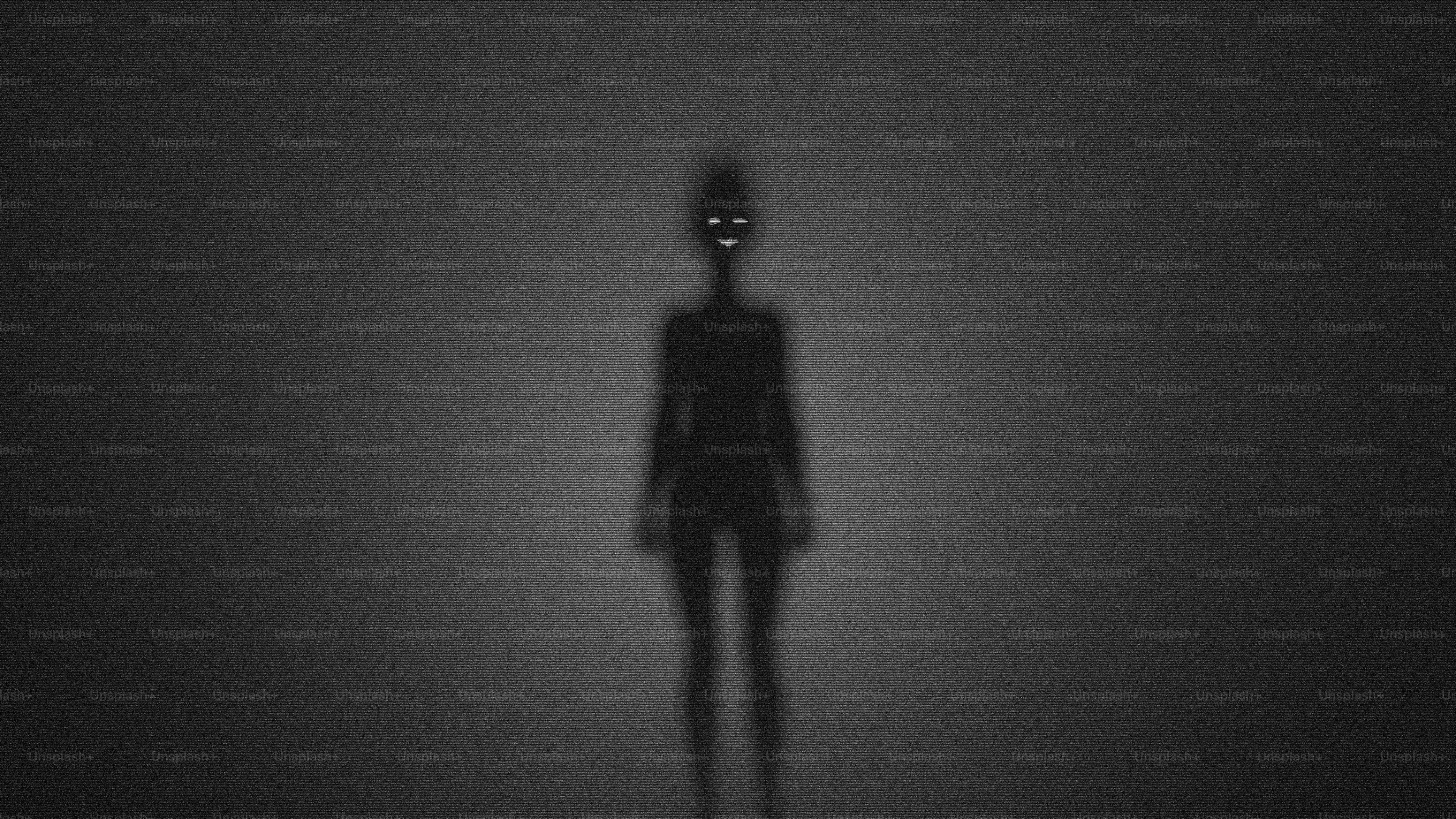 A dark silhouette of a person with glowing eyes and a jagged mouth