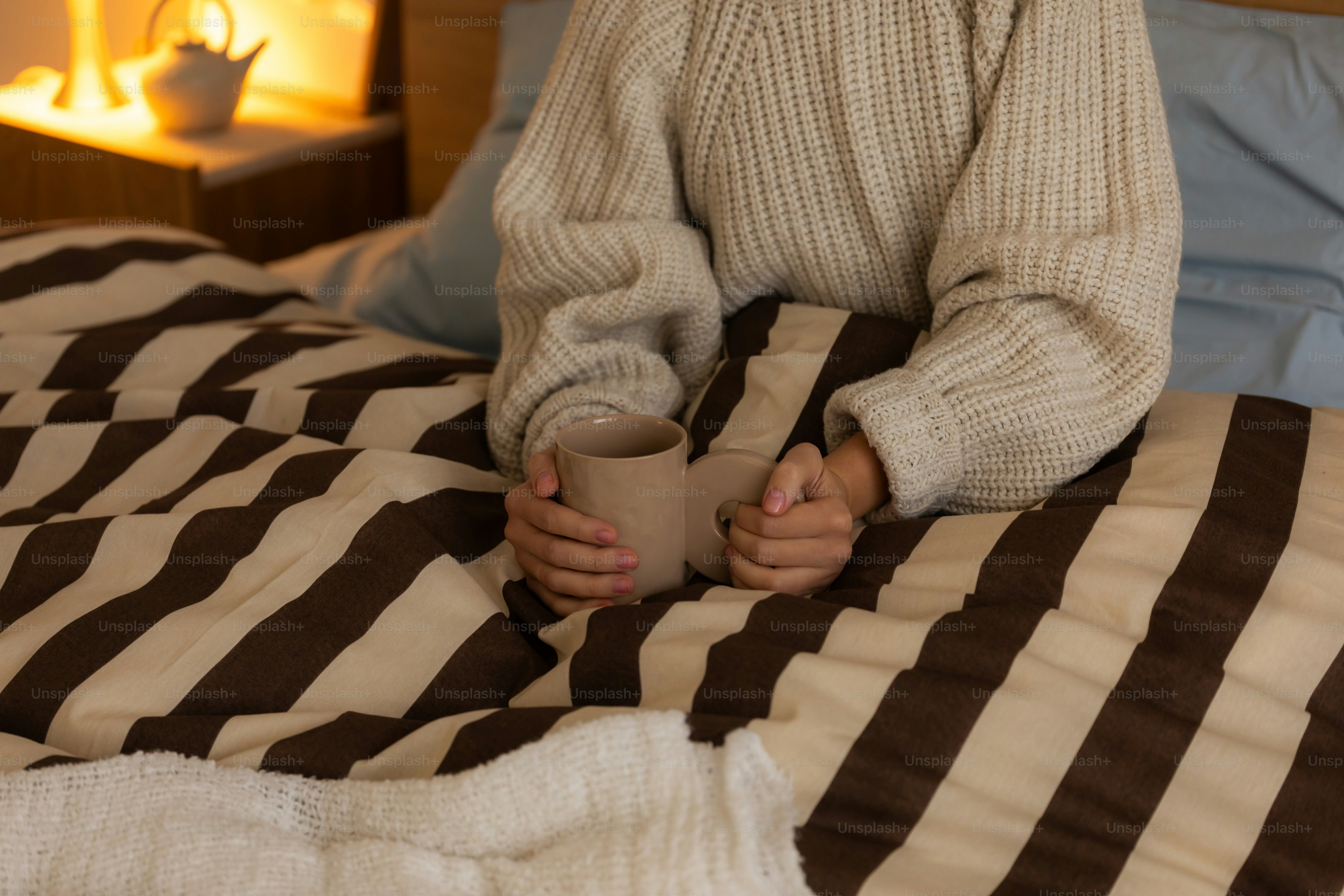 Person in red sweater on bed - Photo on Unsplash+