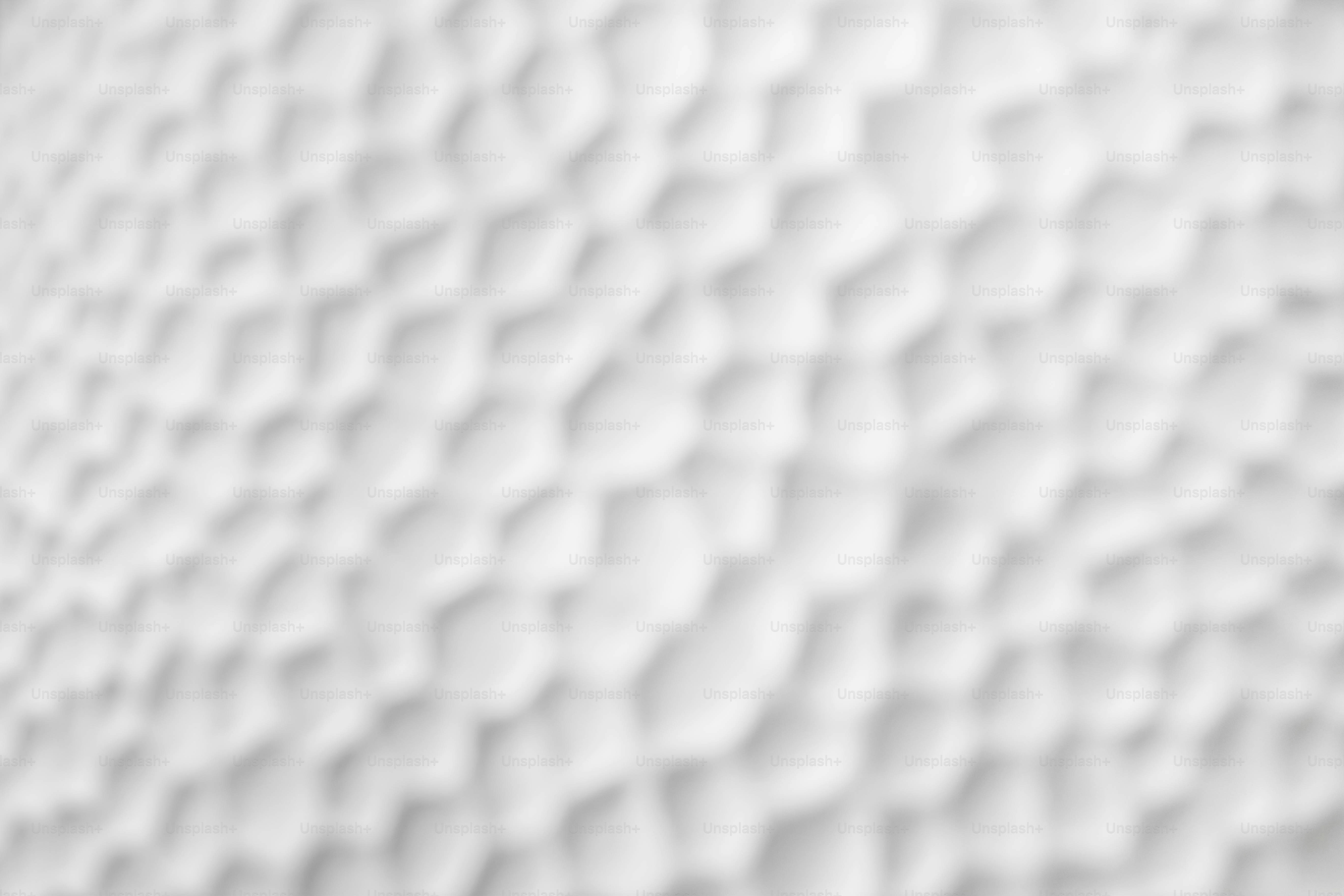 Una superficie blanca borrosa con una textura repetitiva de hoyuelos