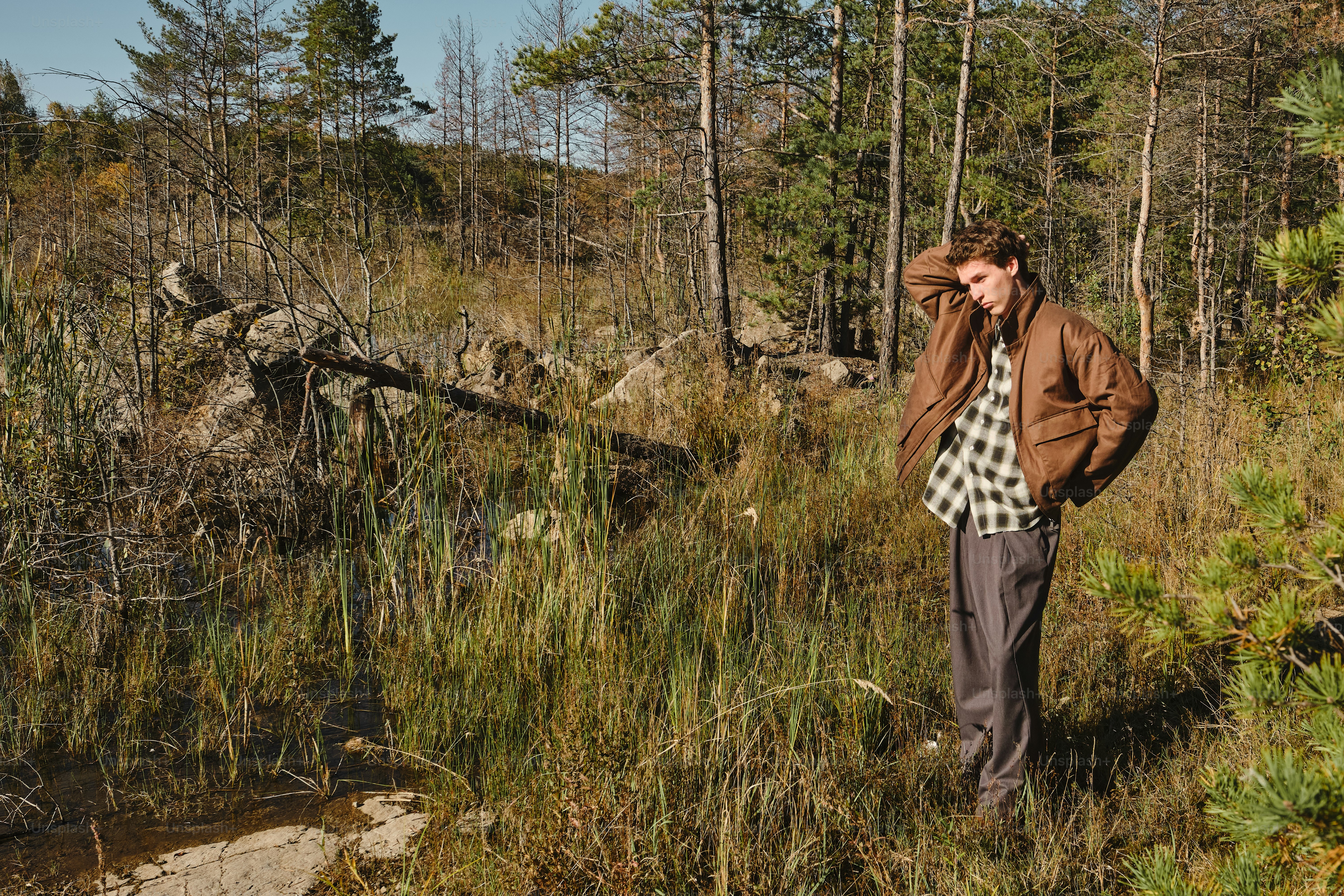 Man in brown jacket in forest - Photo on Unsplash+