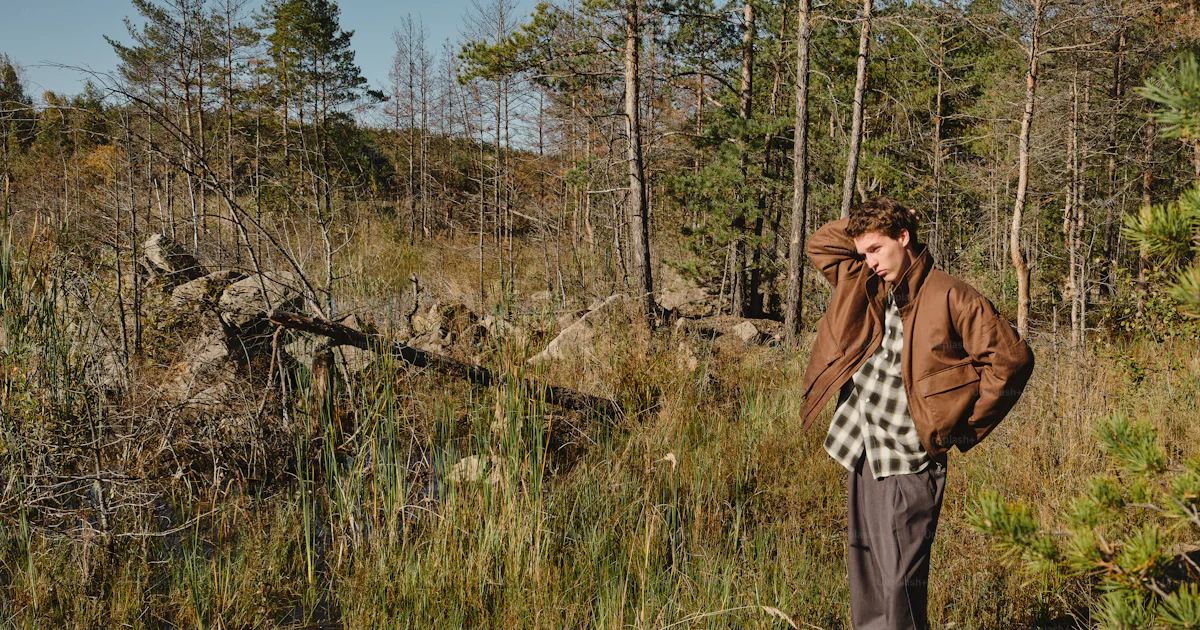 Man in brown jacket in forest - Photo on Unsplash+