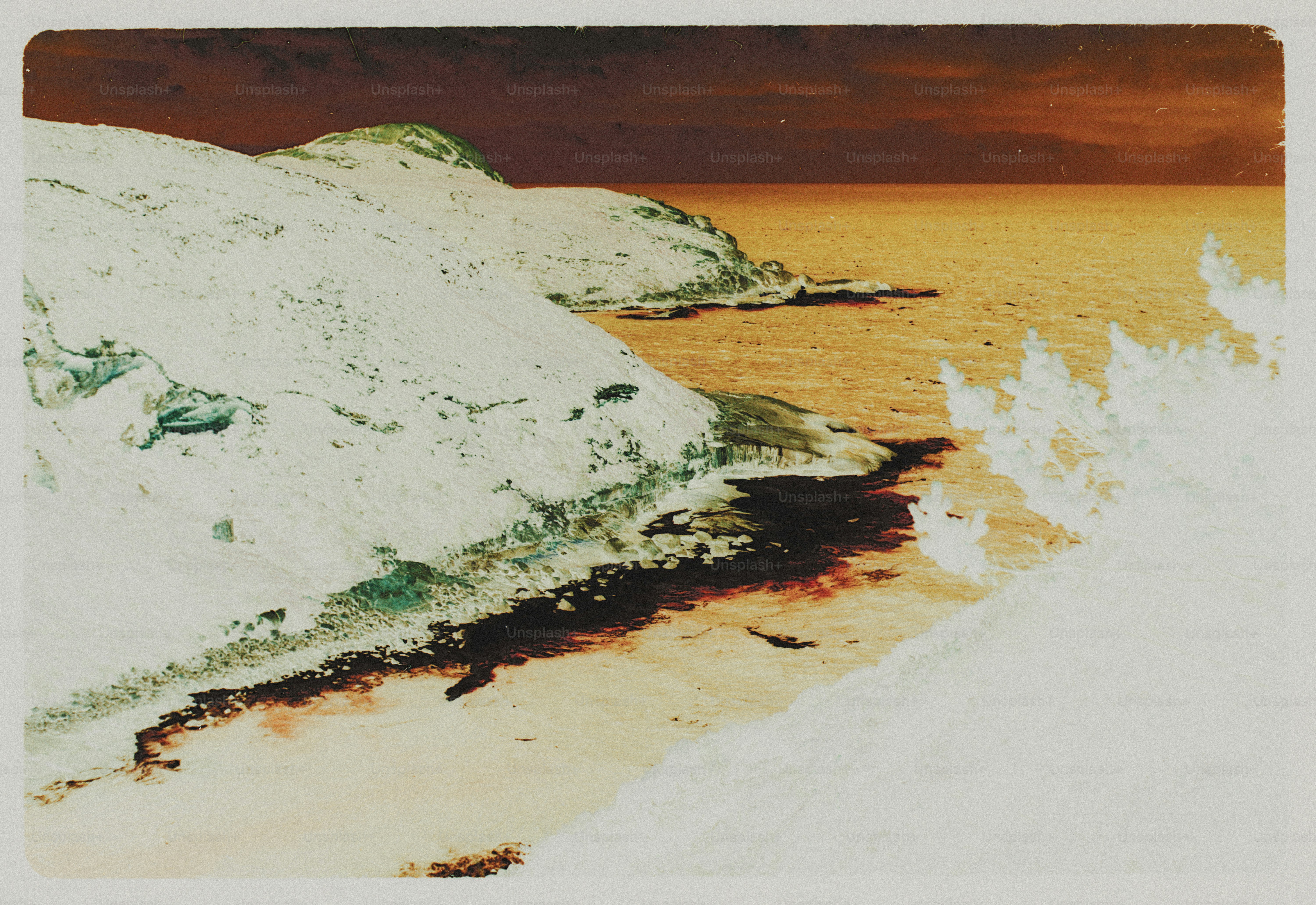 A rocky coastline with inverted colors meeting a dark sea under a deep sky
