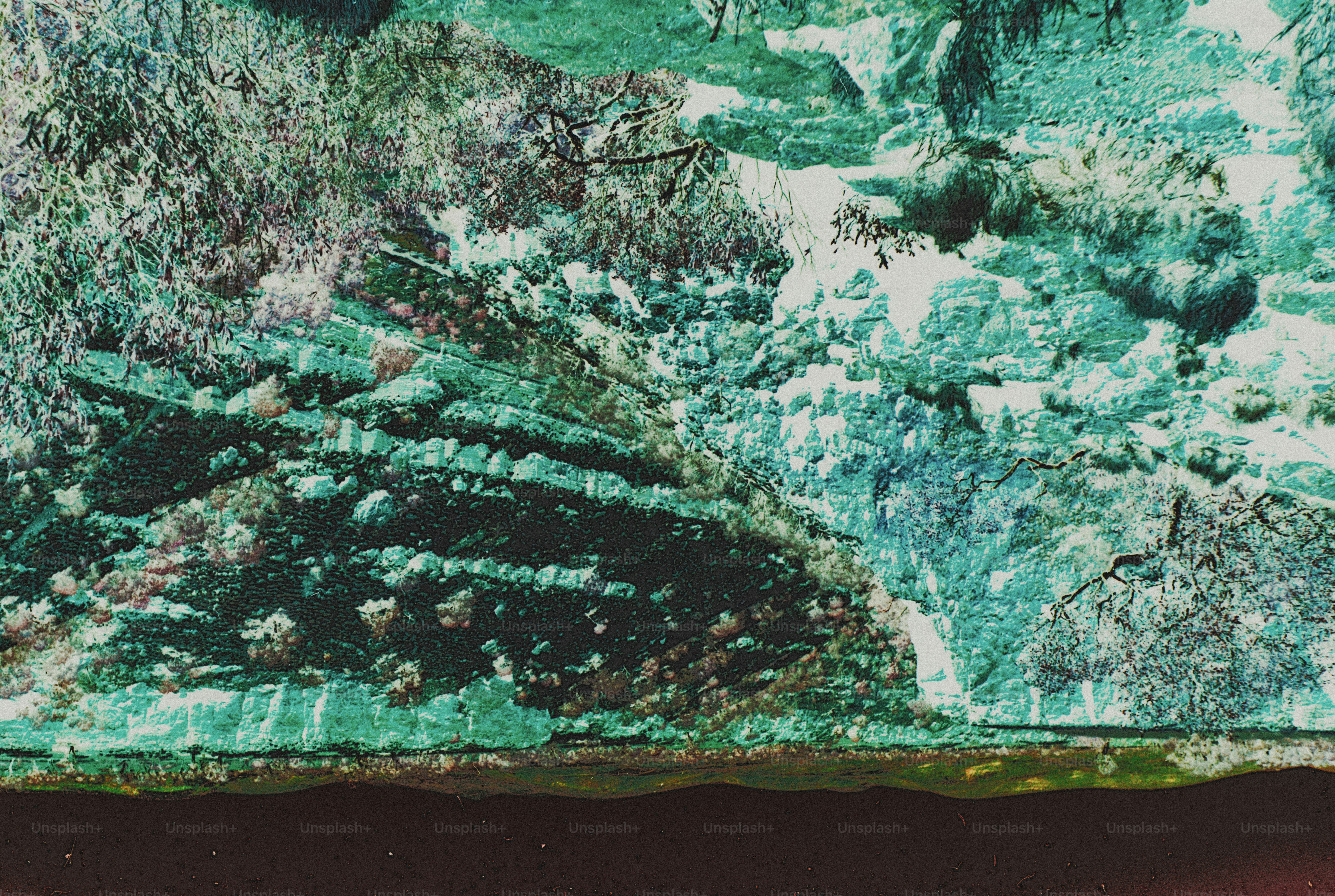 A steep rocky cliff face with layered strata above a dark still pool