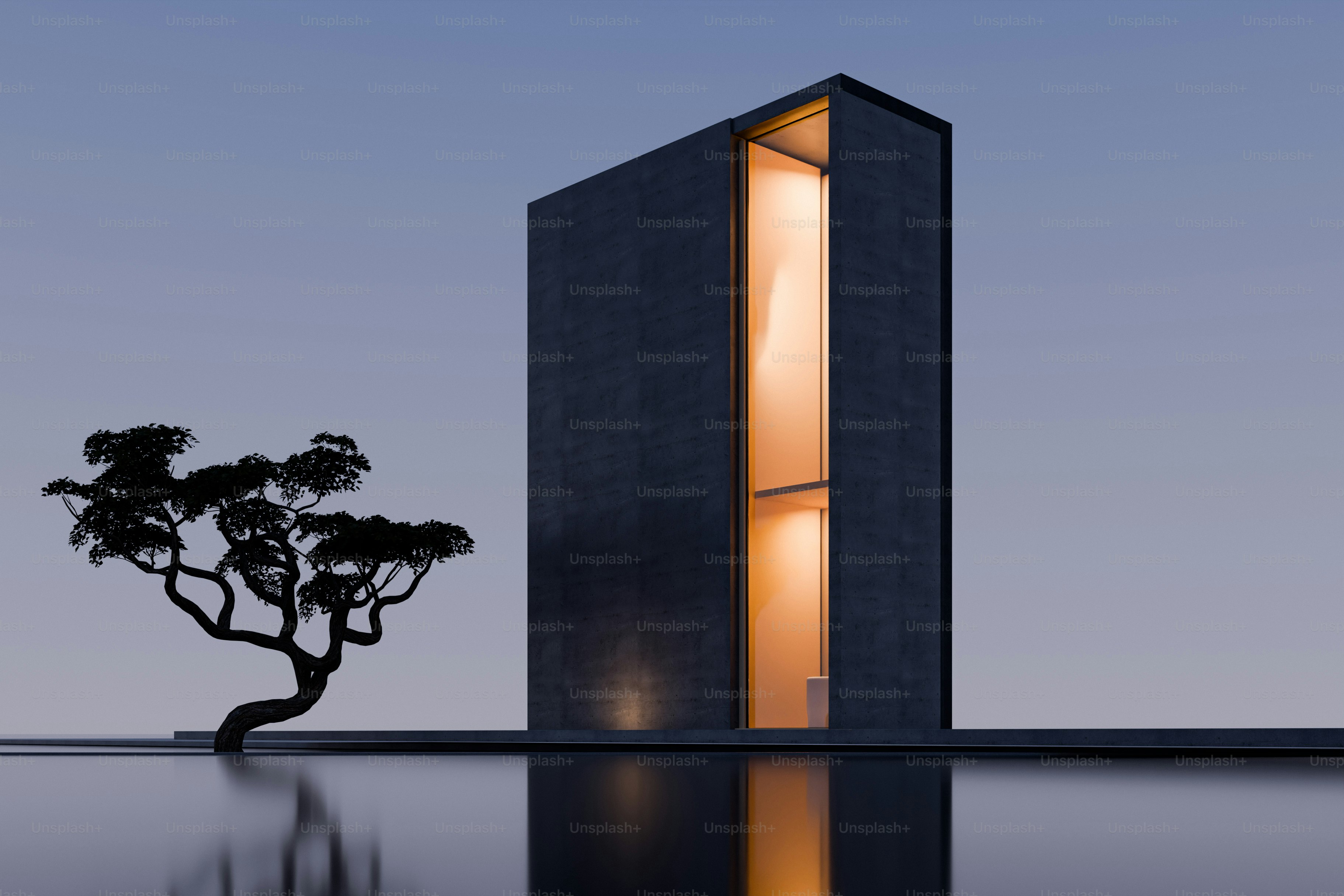 Un edificio moderno oscuro con una ventana vertical luminosa junto a un pequeño árbol
