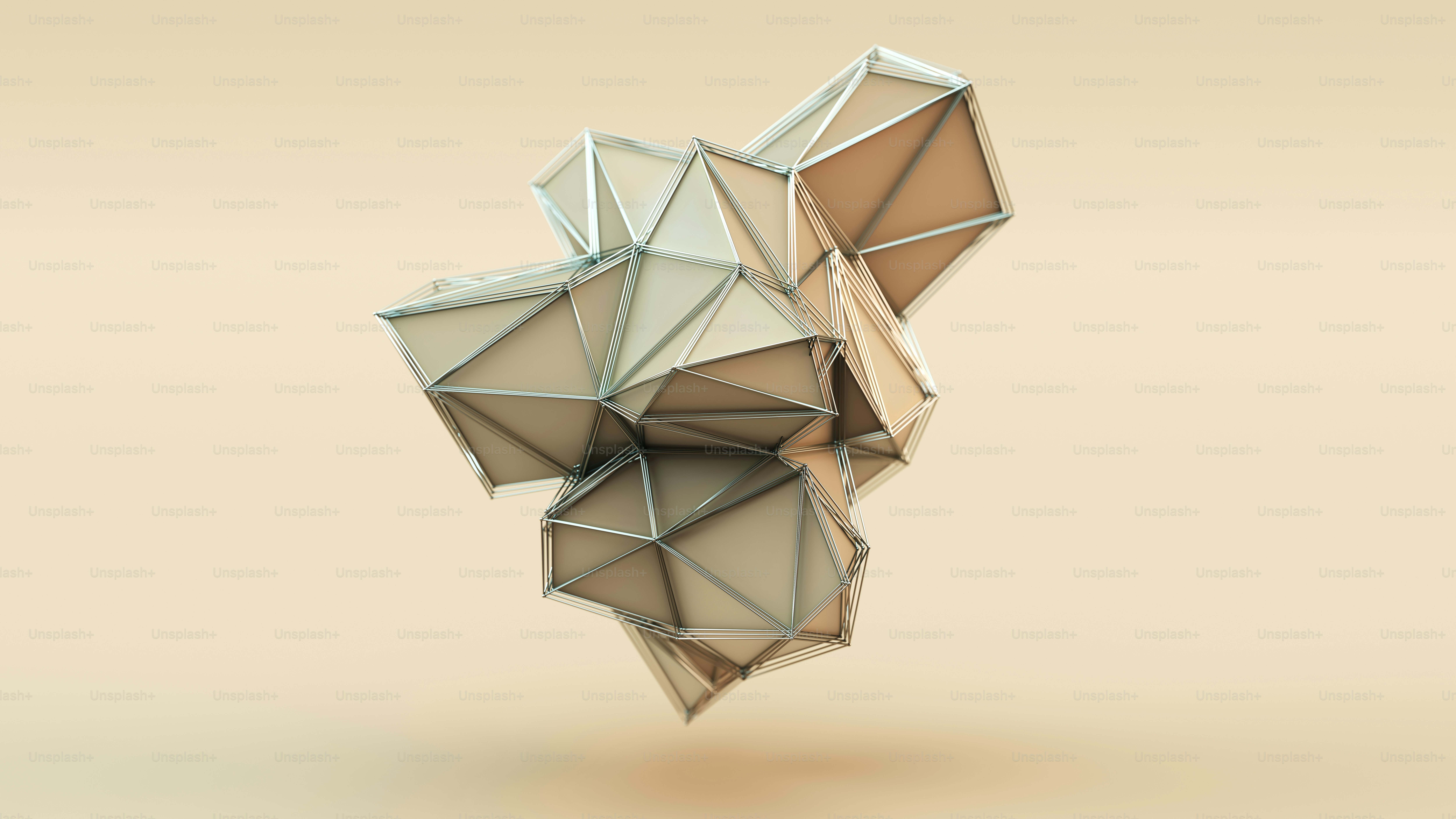 A beige geometric sculpture with metallic wireframe edges against a matching solid background