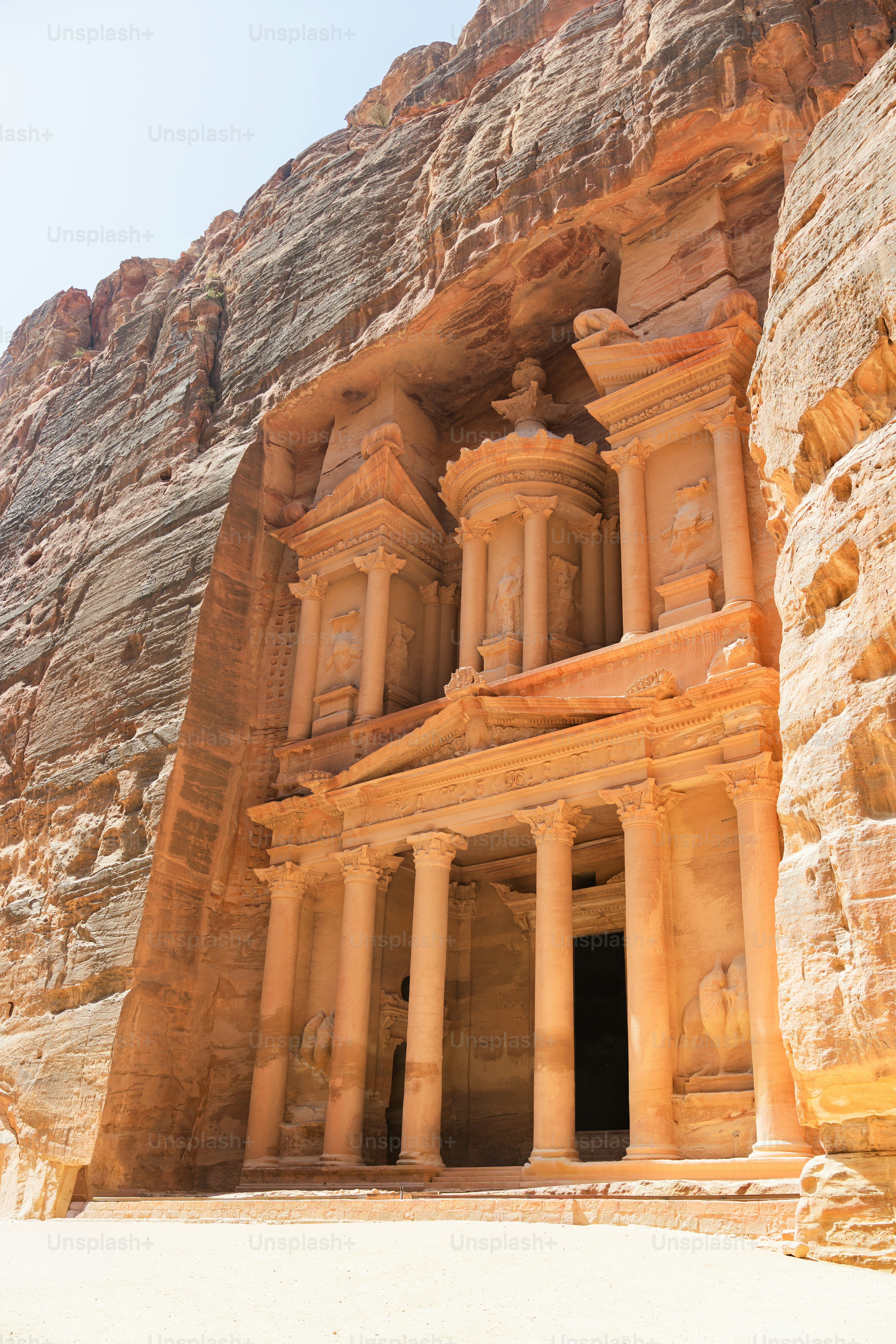 The Treasury carved into a sandstone cliff face in Wadi Musa, Jordan