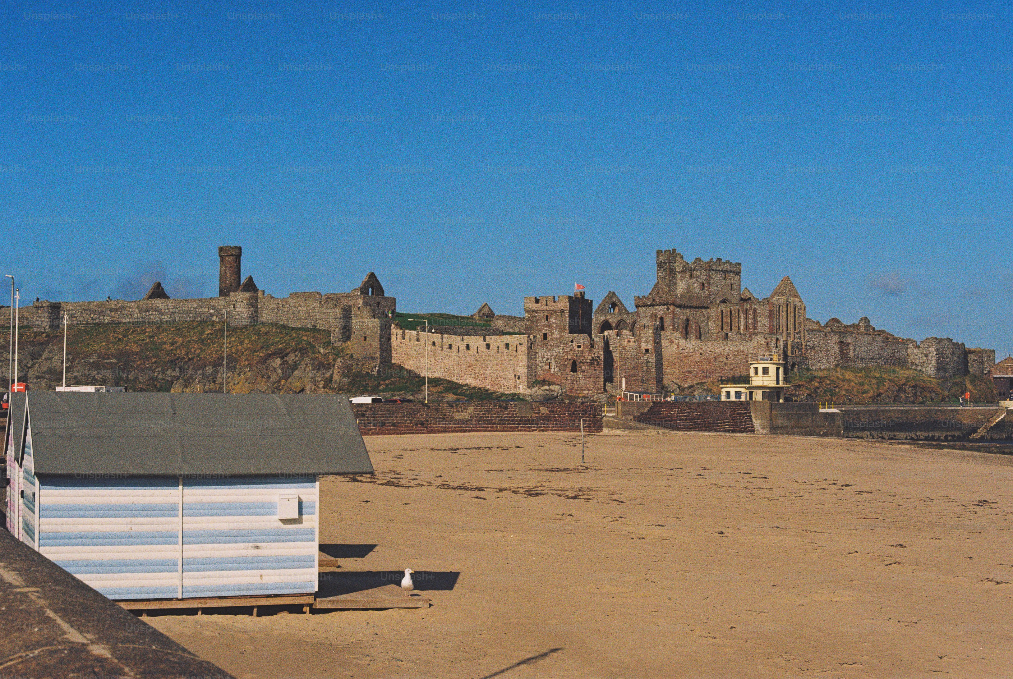 Peel Castle ruins on sandy beach - Photo on Unsplash+