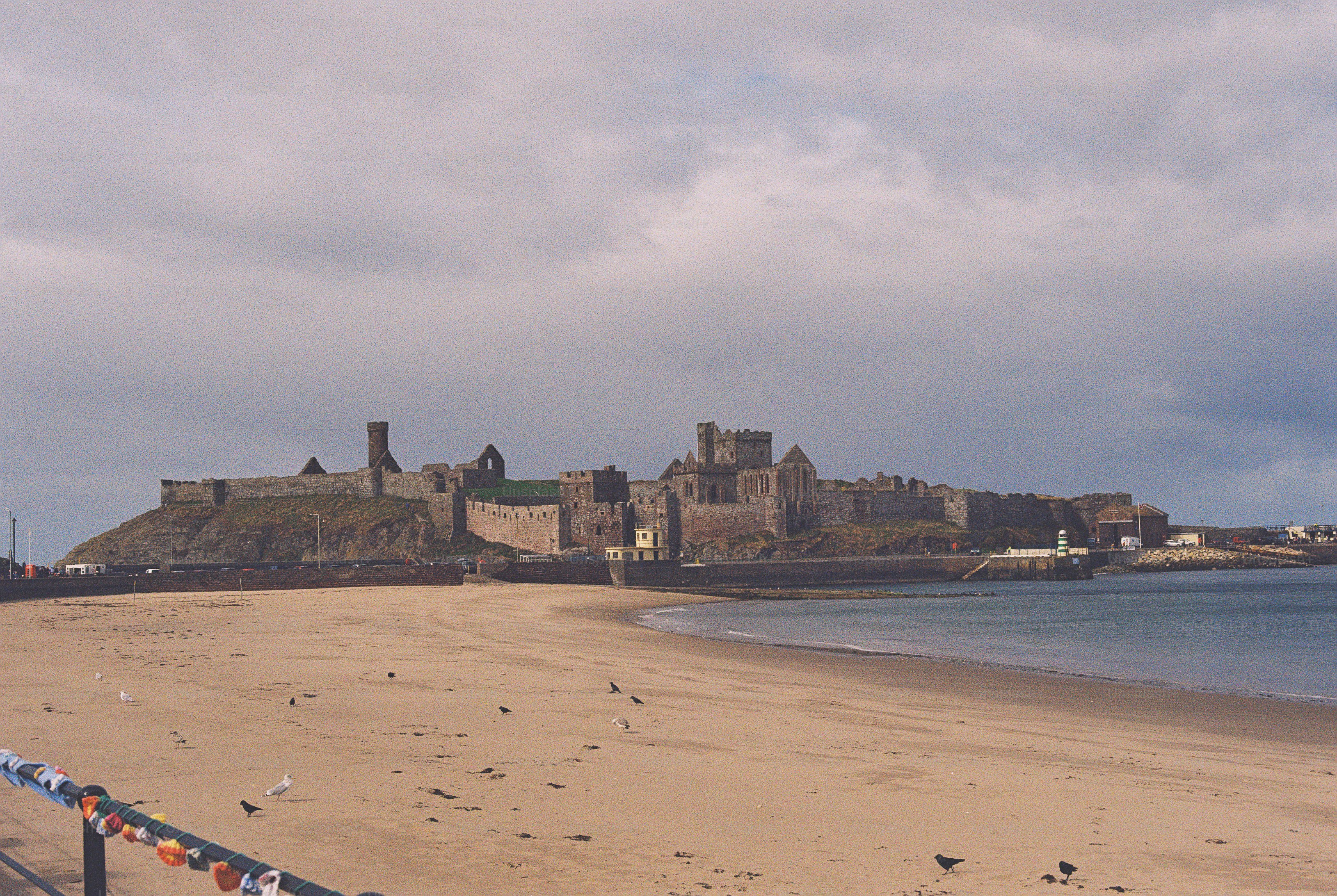 Peel Castle ruins on sandy beach - Photo on Unsplash+