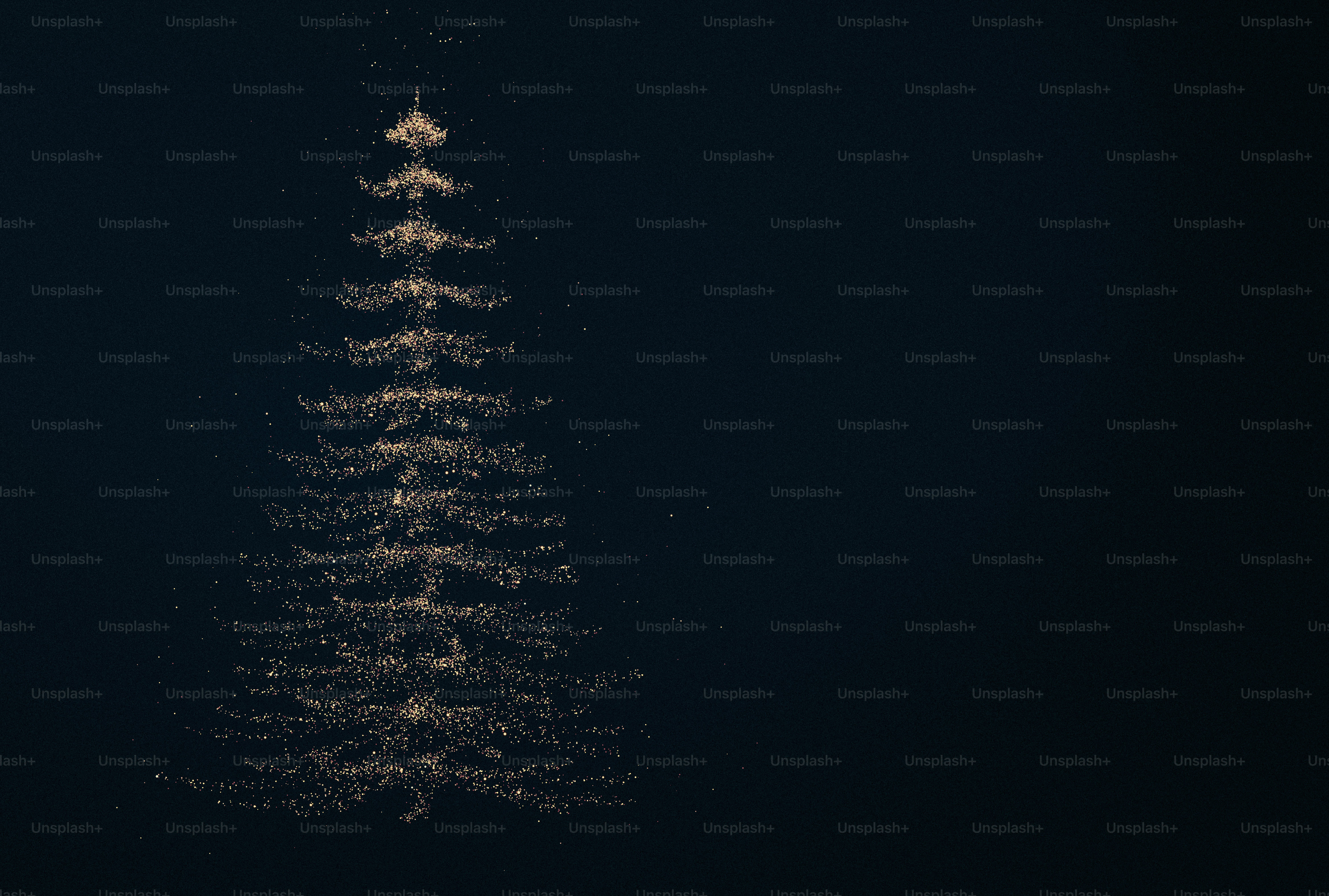 A Christmas tree shape formed by golden glitter particles against a dark background