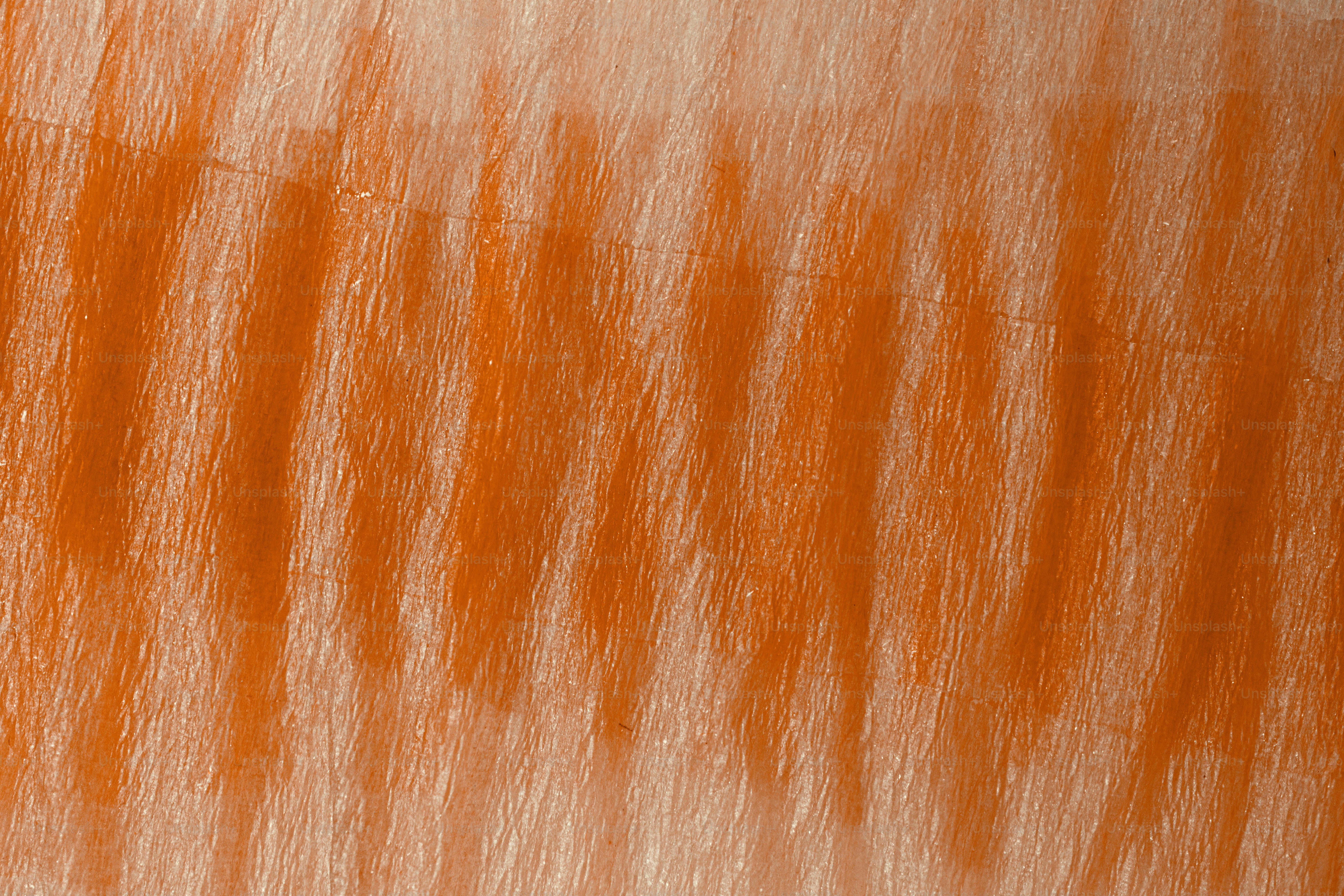 Vertical orange crayon strokes on a textured beige paper background