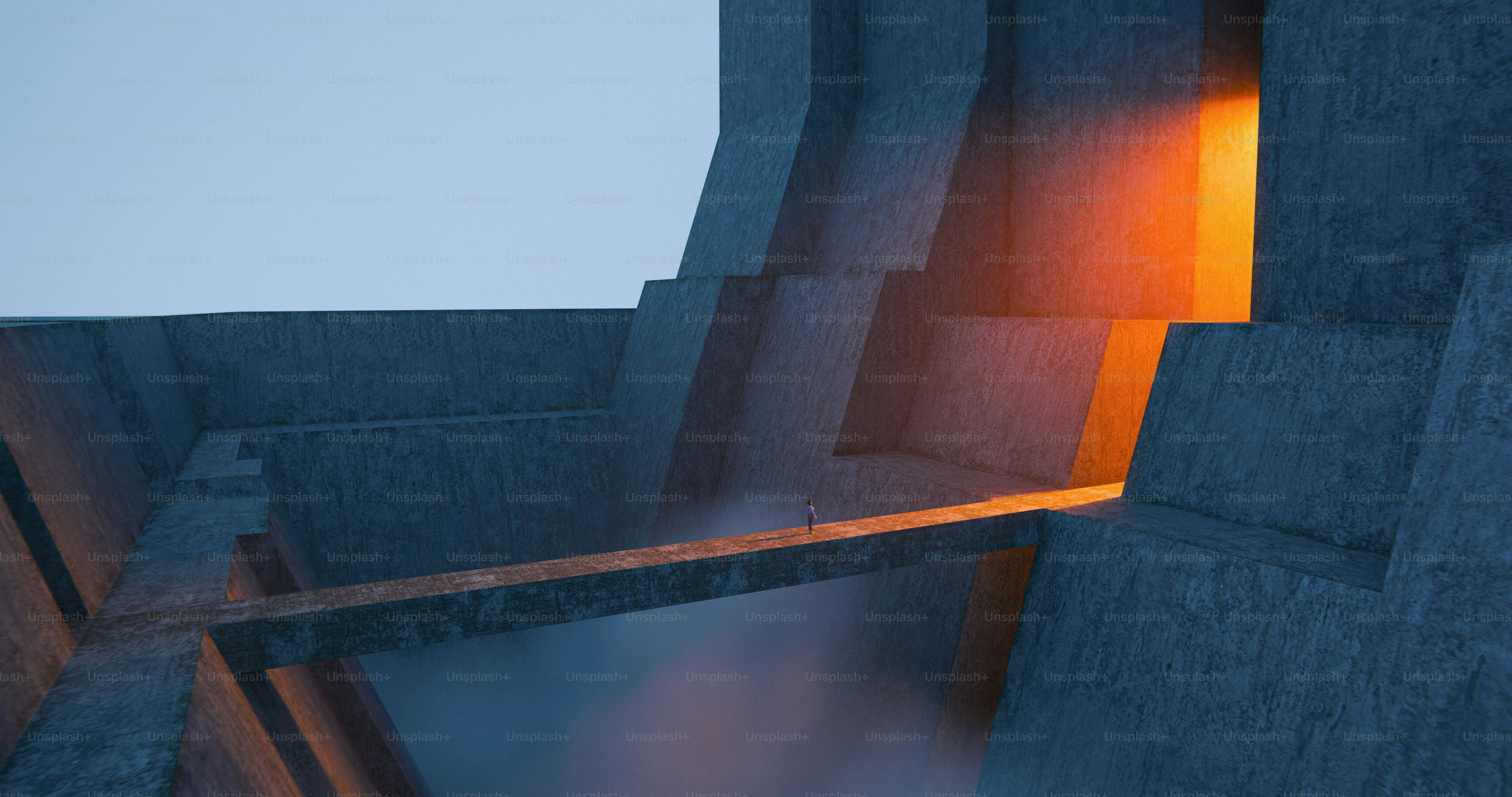 A person walking on a narrow bridge between massive concrete walls toward orange light