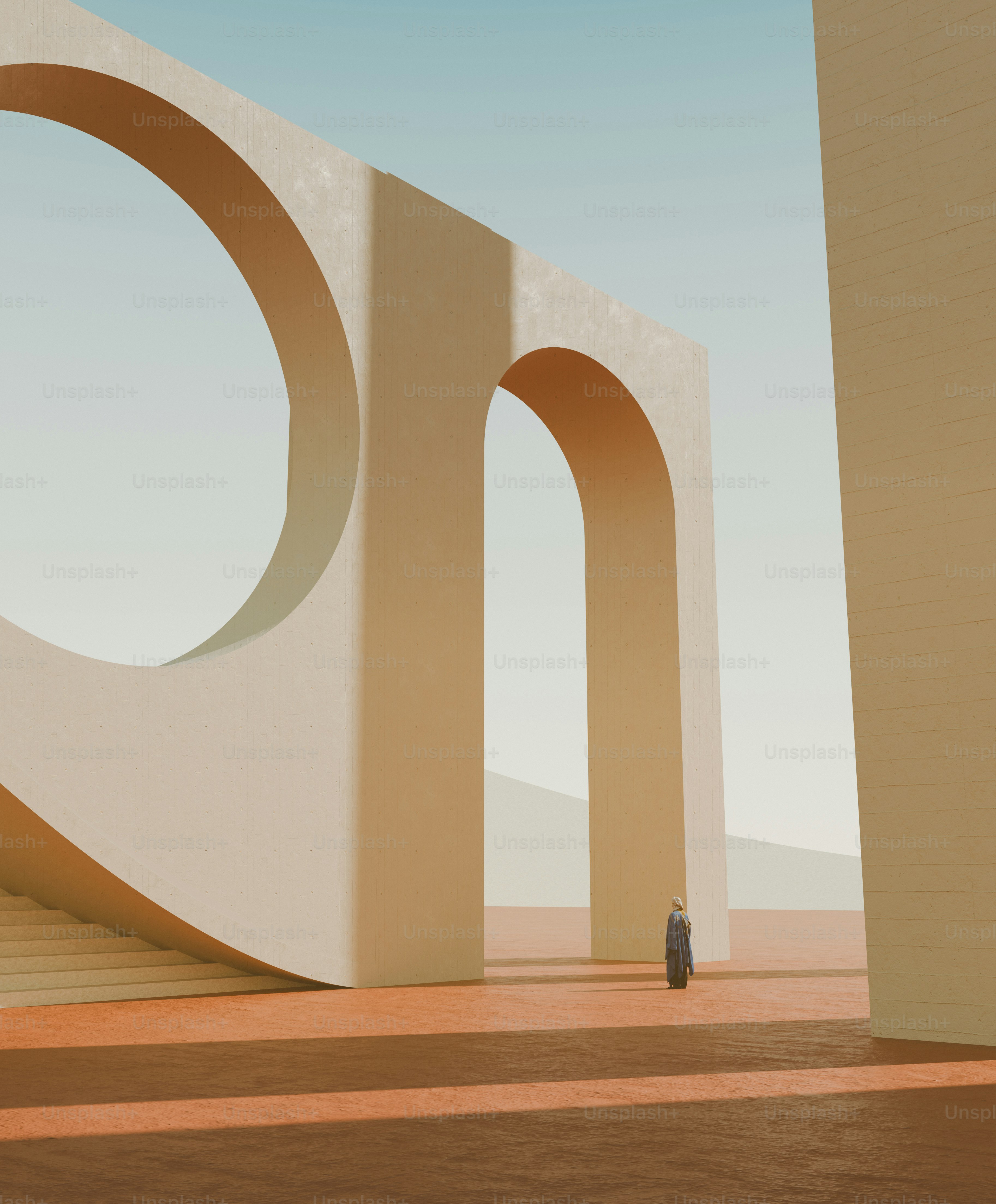 A person in a long coat walking through large beige concrete arches