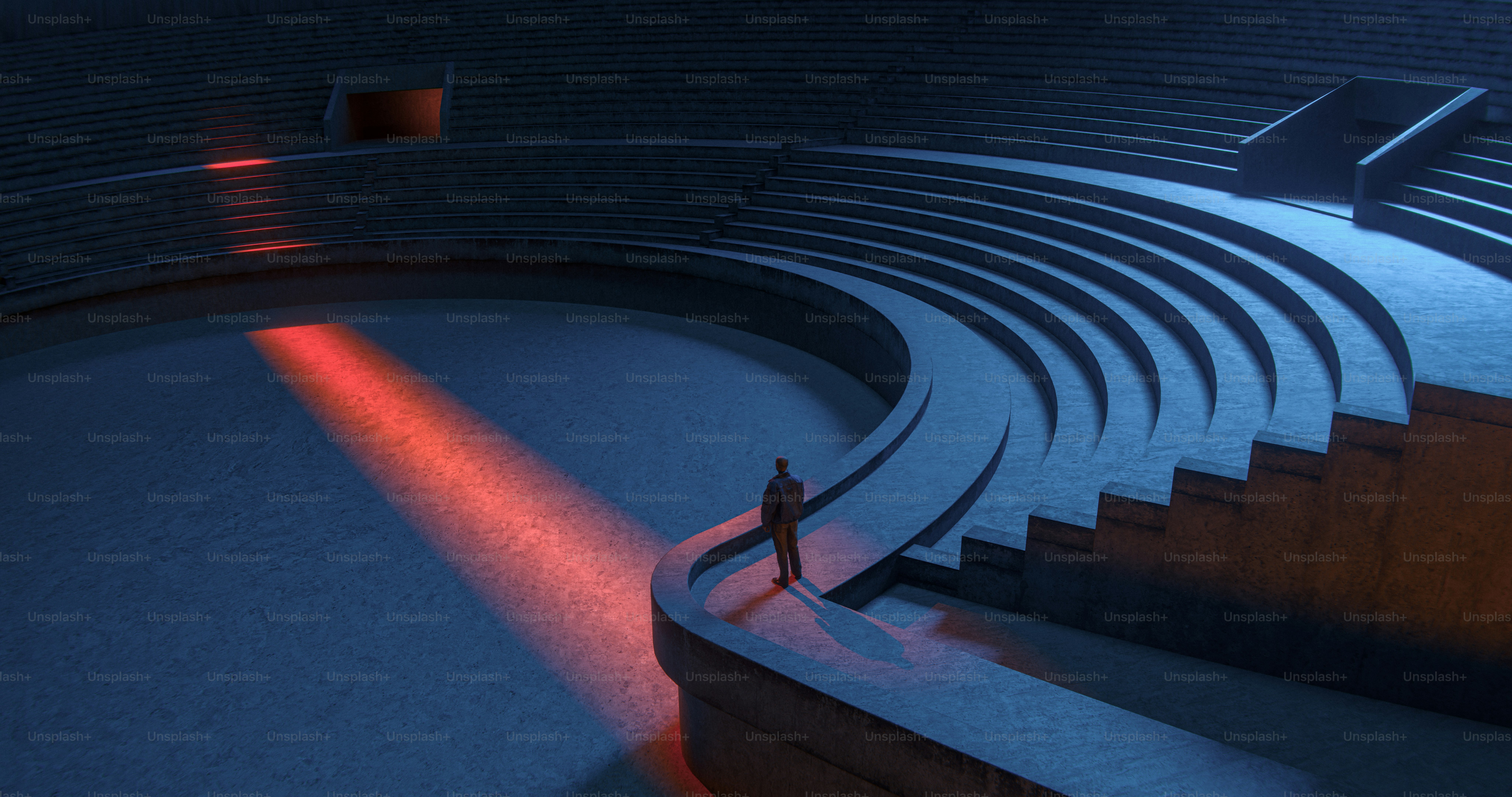 A person in a dark jacket on the curved concrete steps of an amphitheater