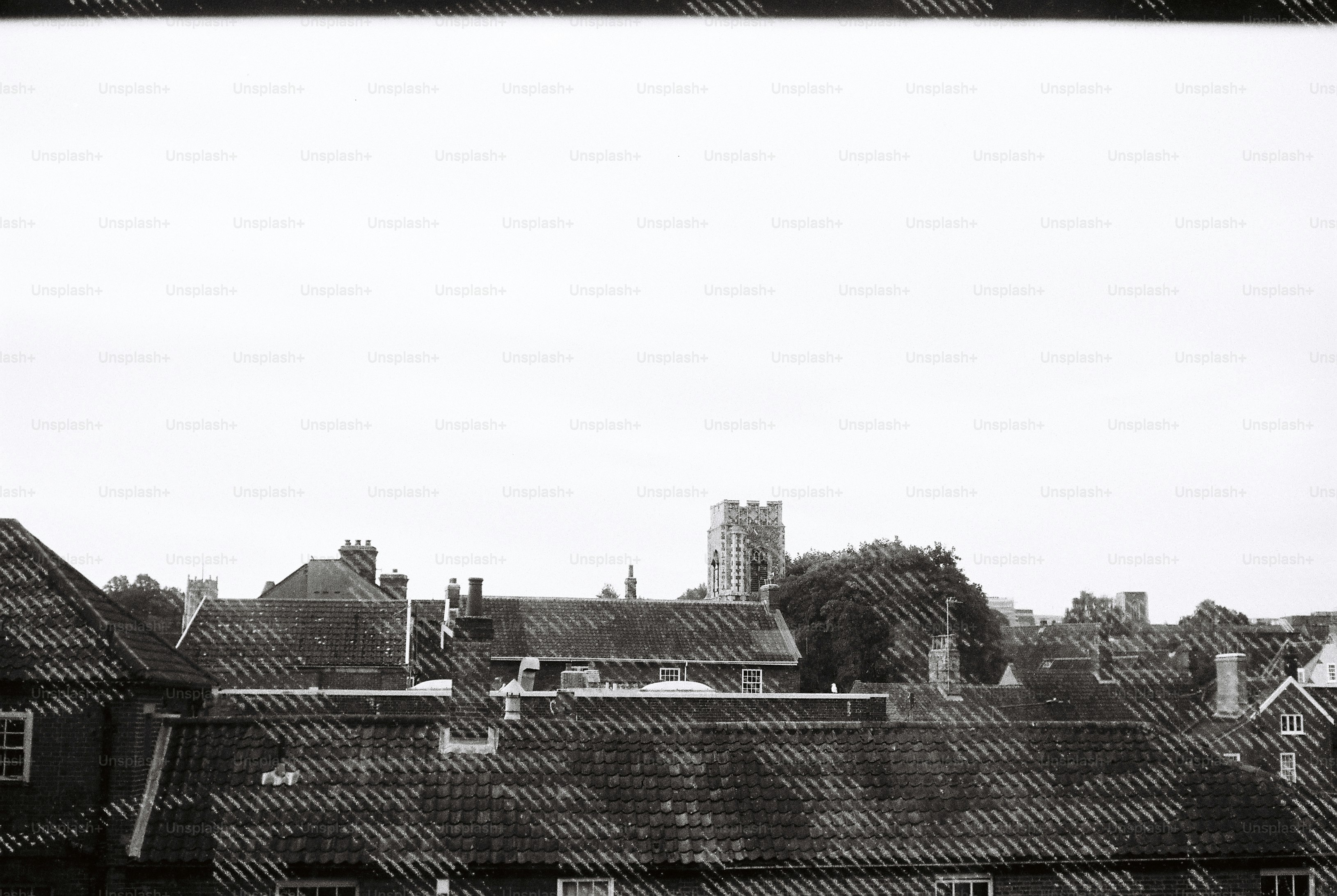 A church tower rising above the tiled roofs of a town