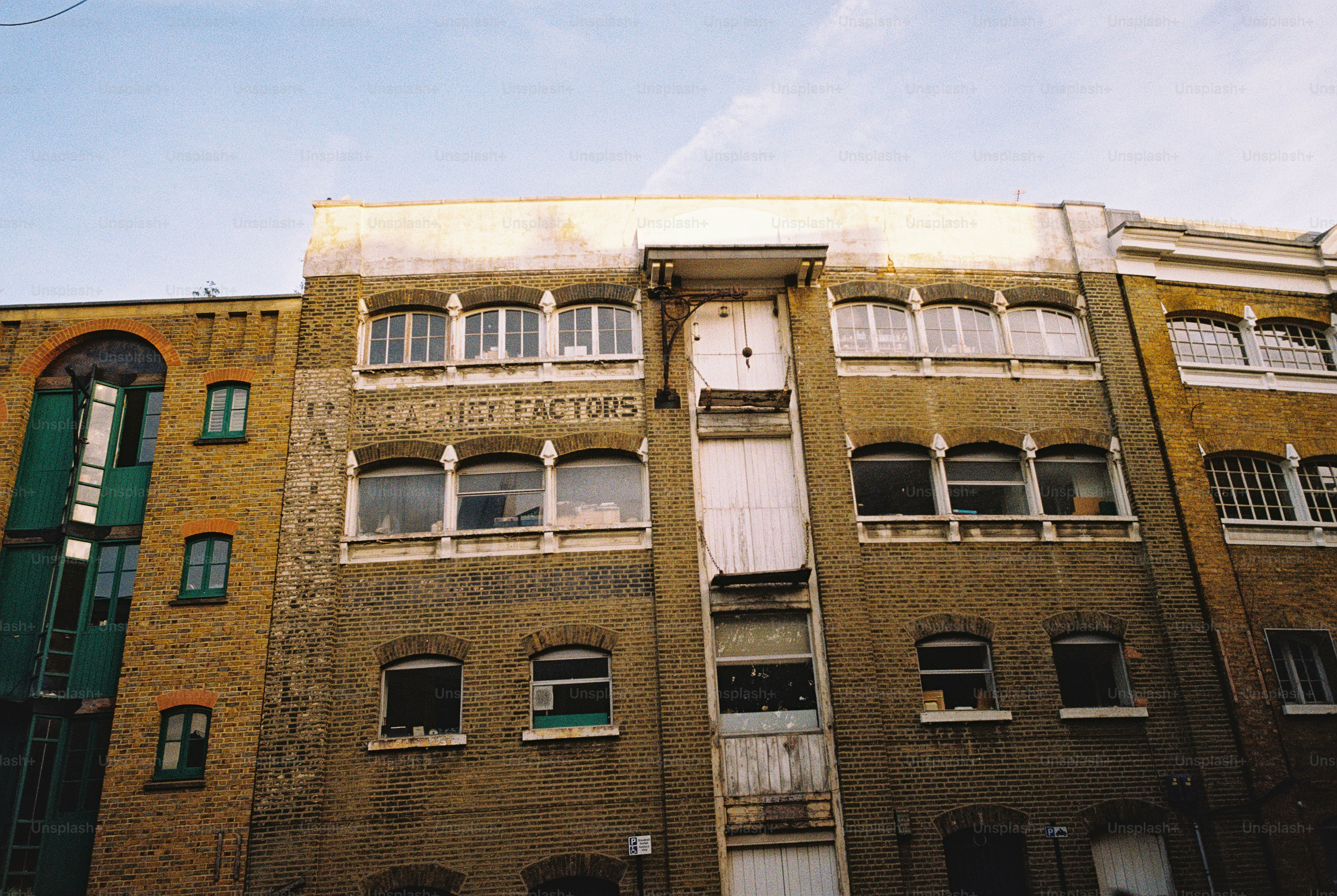 Victorian brick warehouse with hoist doors - Photo on Unsplash+