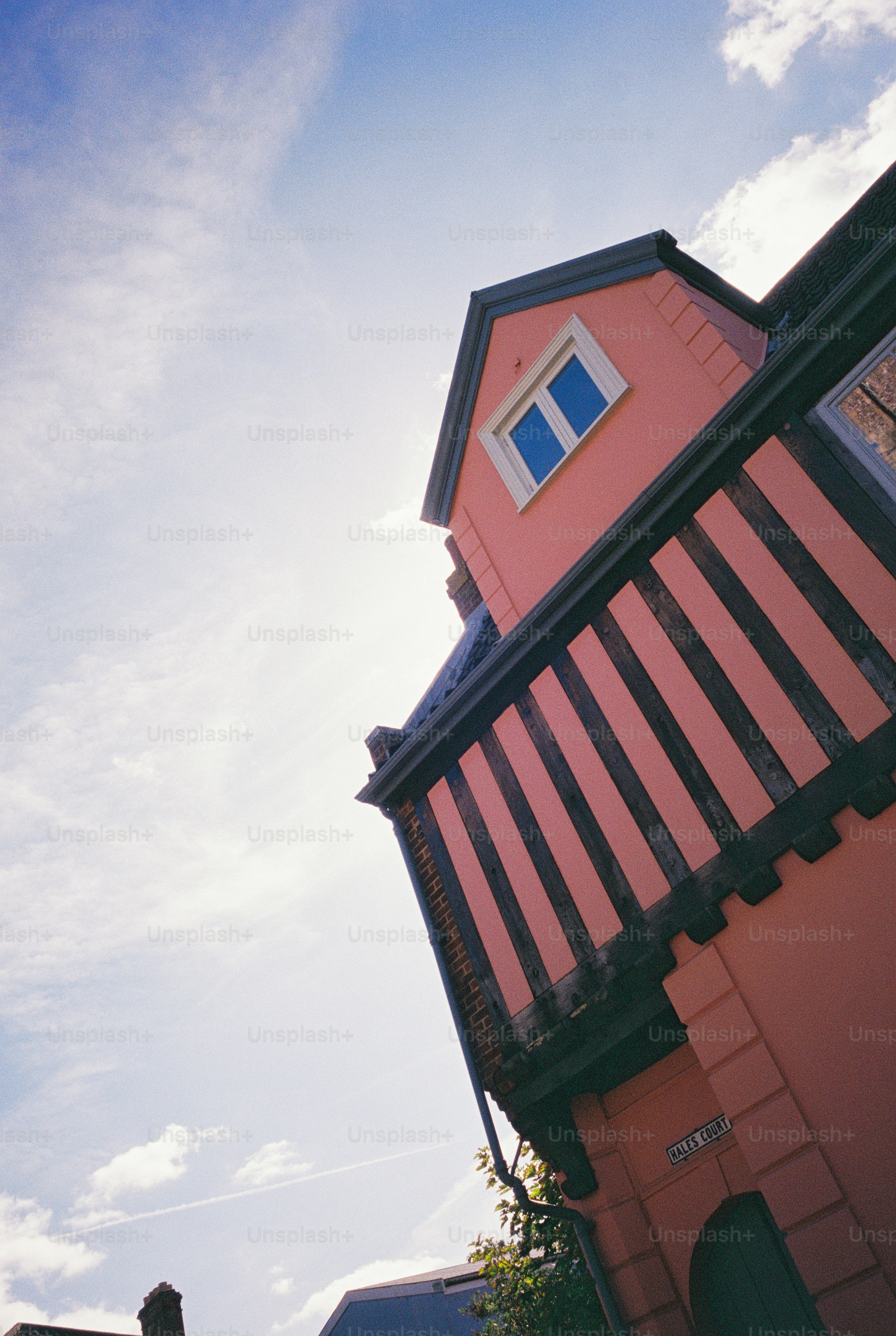 A pink timber-framed building with a jettied upper storey in Norwich, United Kingdom