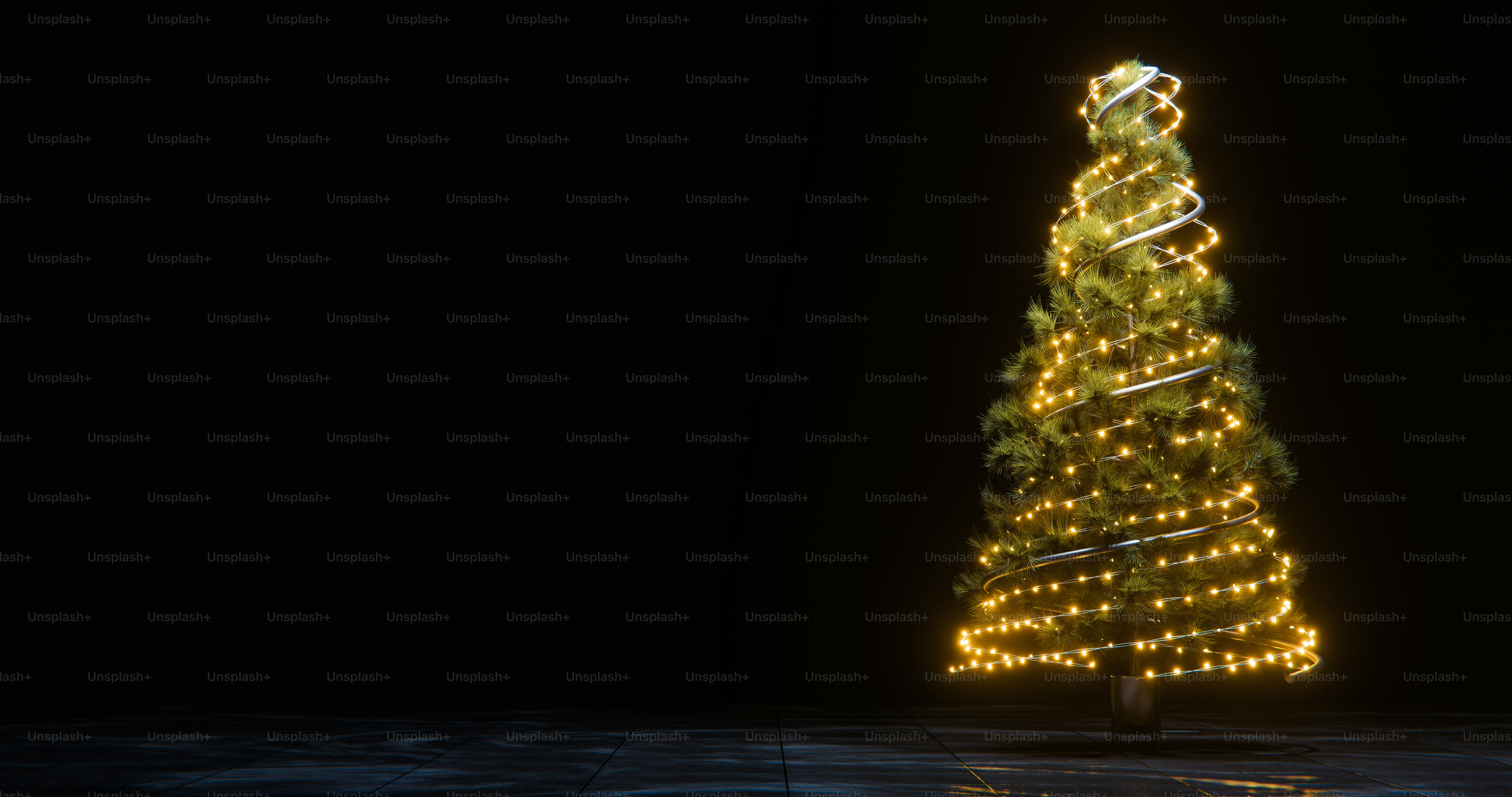 A Christmas tree wrapped in glowing warm fairy lights against a dark background