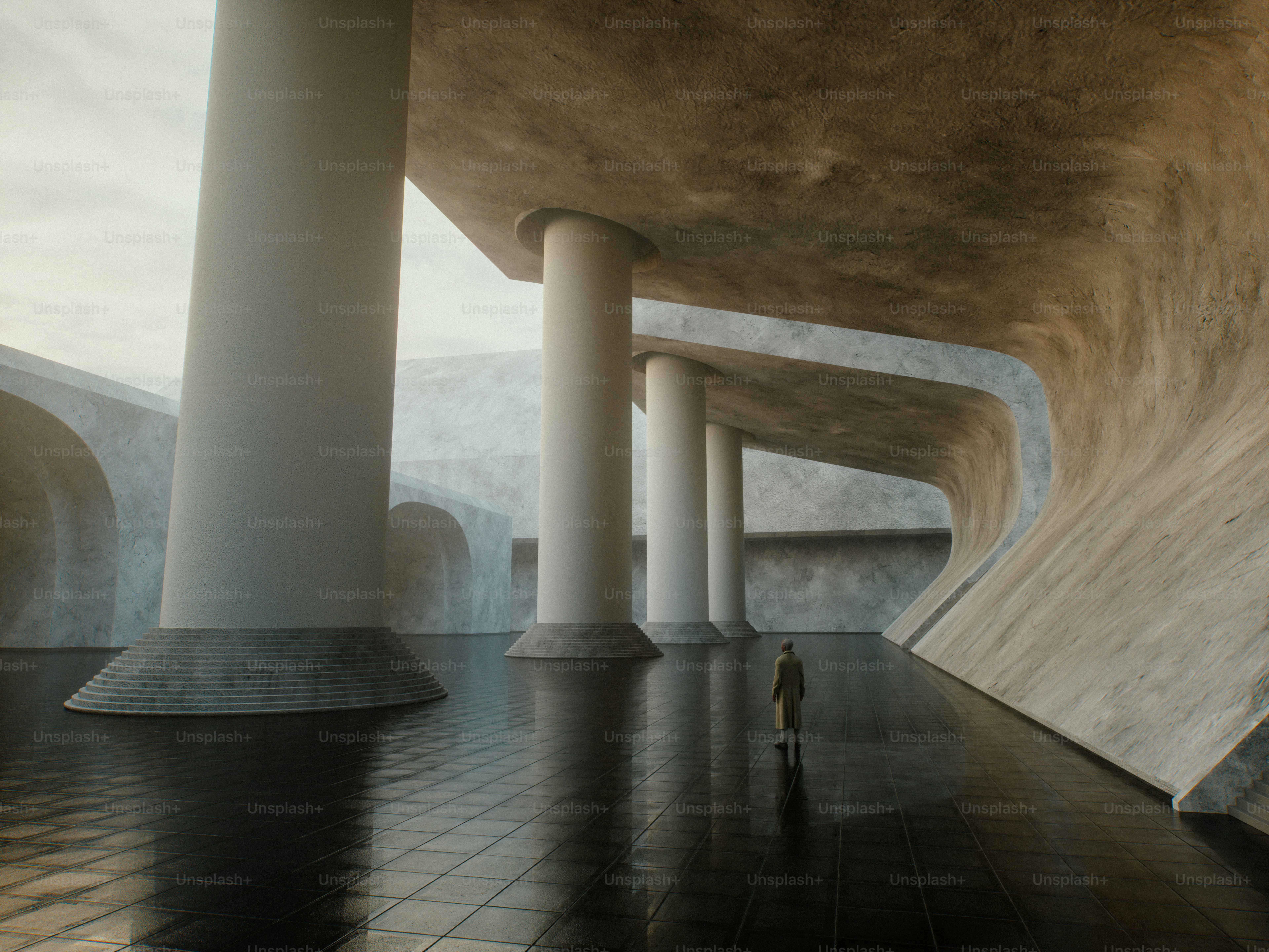 A person in a long coat standing in a vast hall with concrete columns