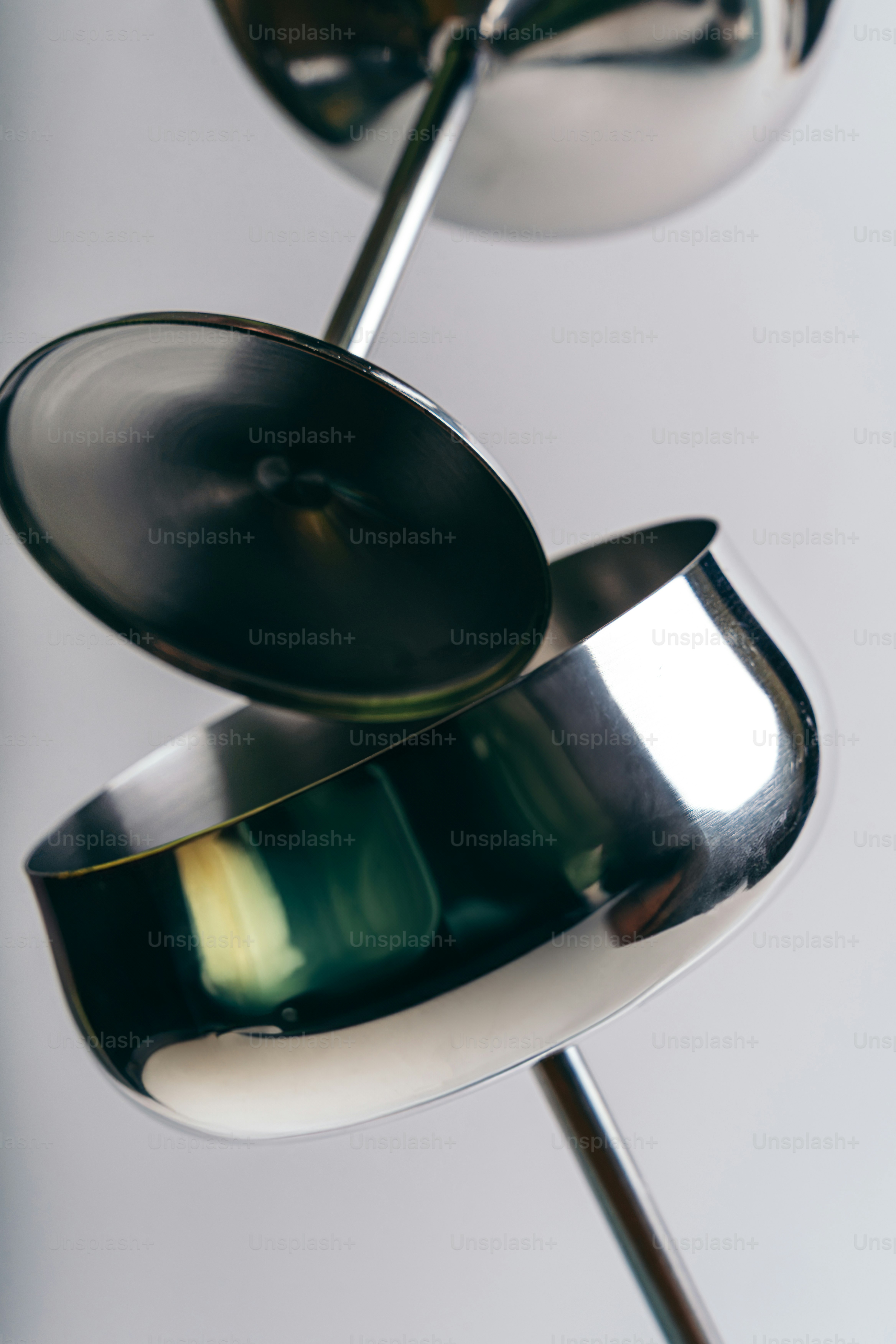Polished metal sculpture with circular bowls - Photo on Unsplash+