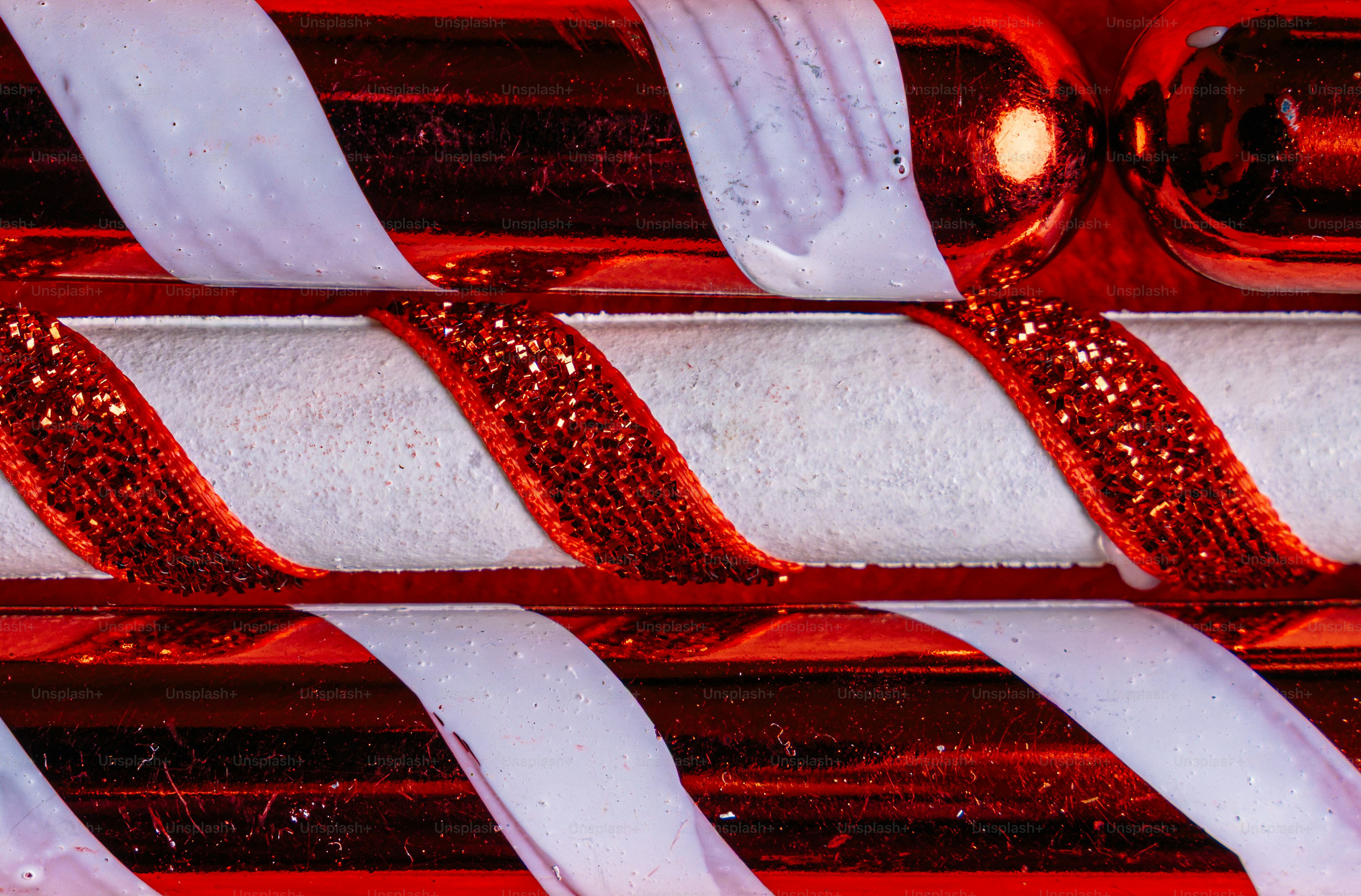 Close-up of red and white striped candy canes with glittery texture