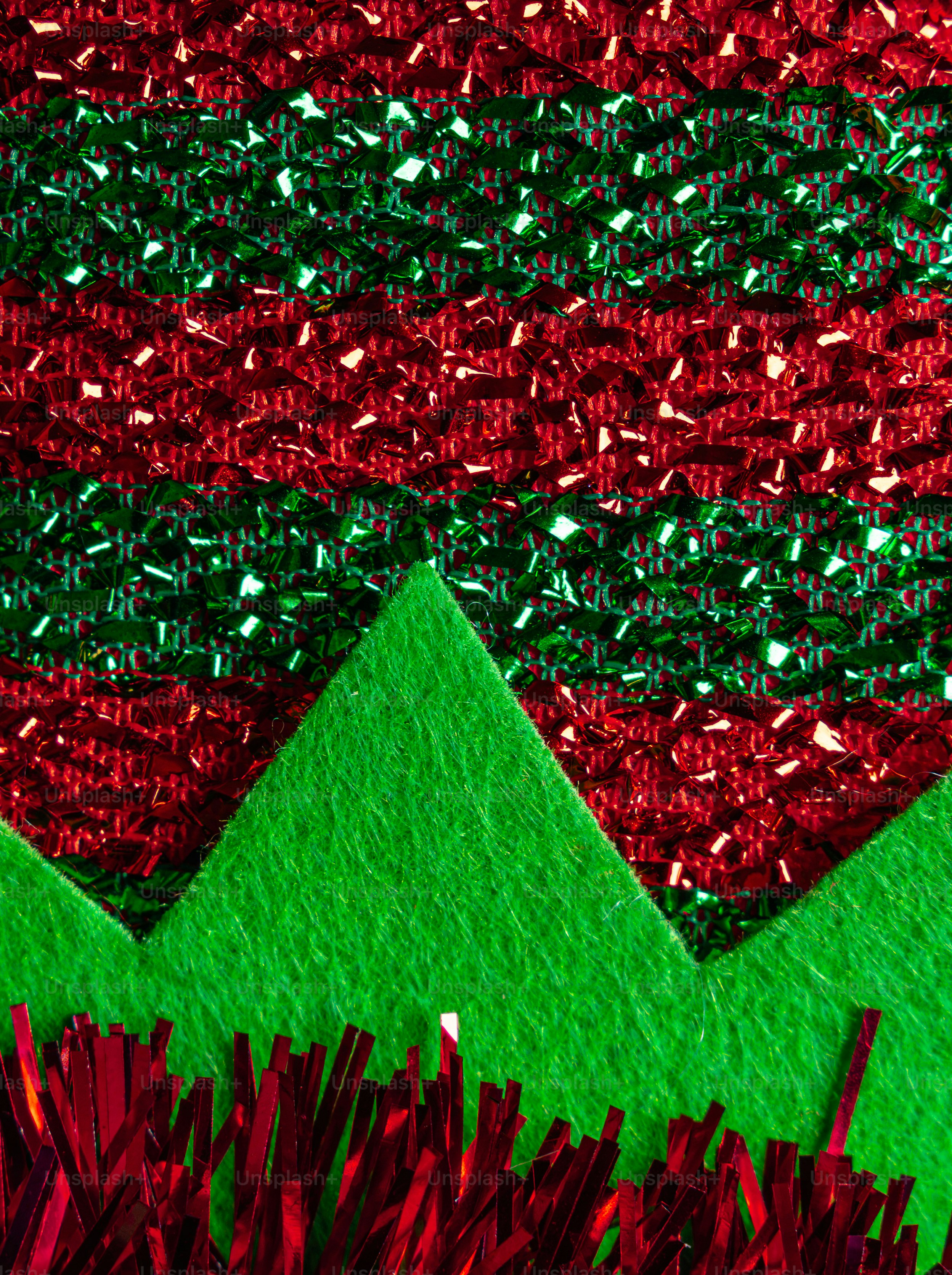 Red and green metallic tinsel strips layered over green felt triangles
