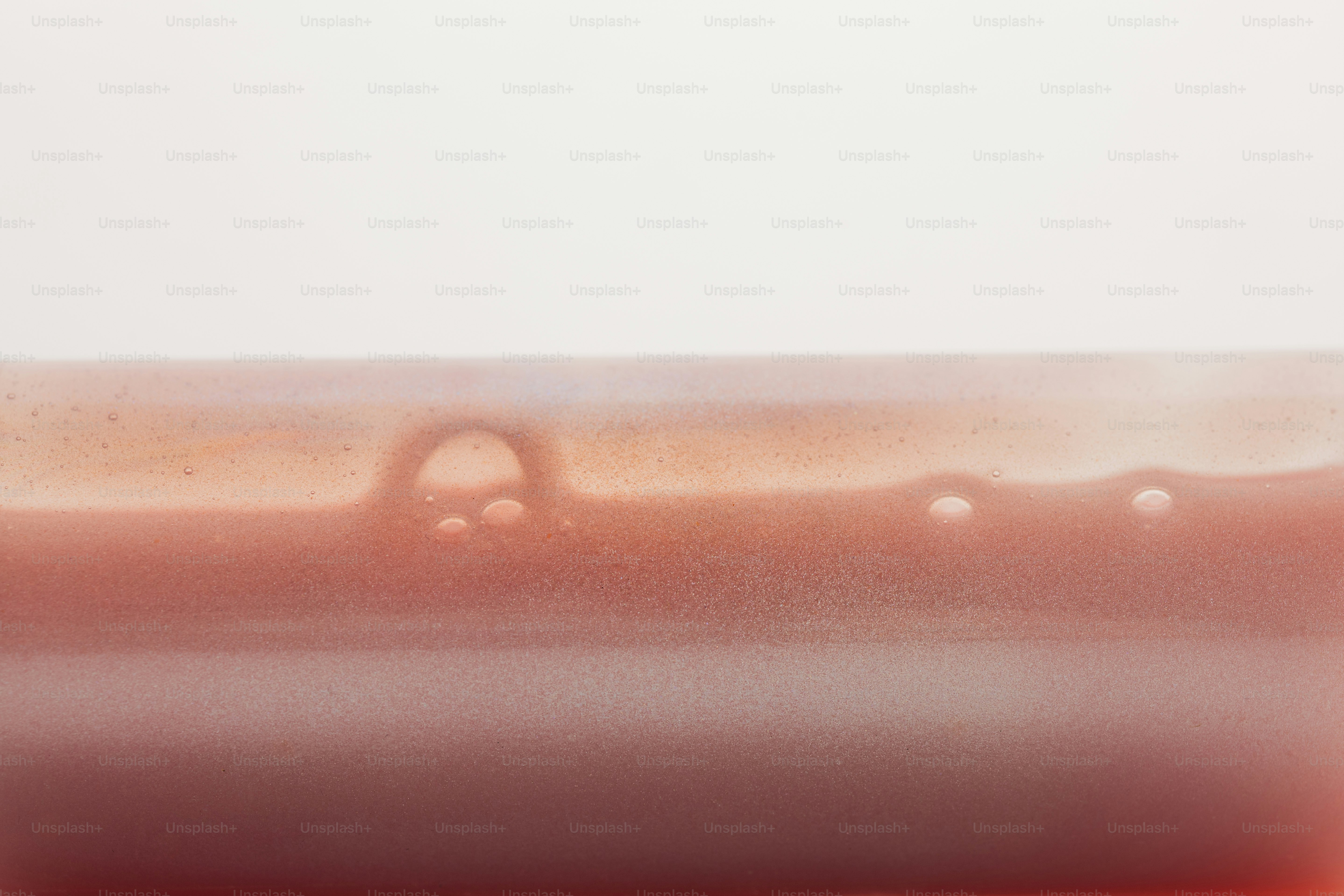 A close-up of a smooth brown liquid with small bubbles on the surface
