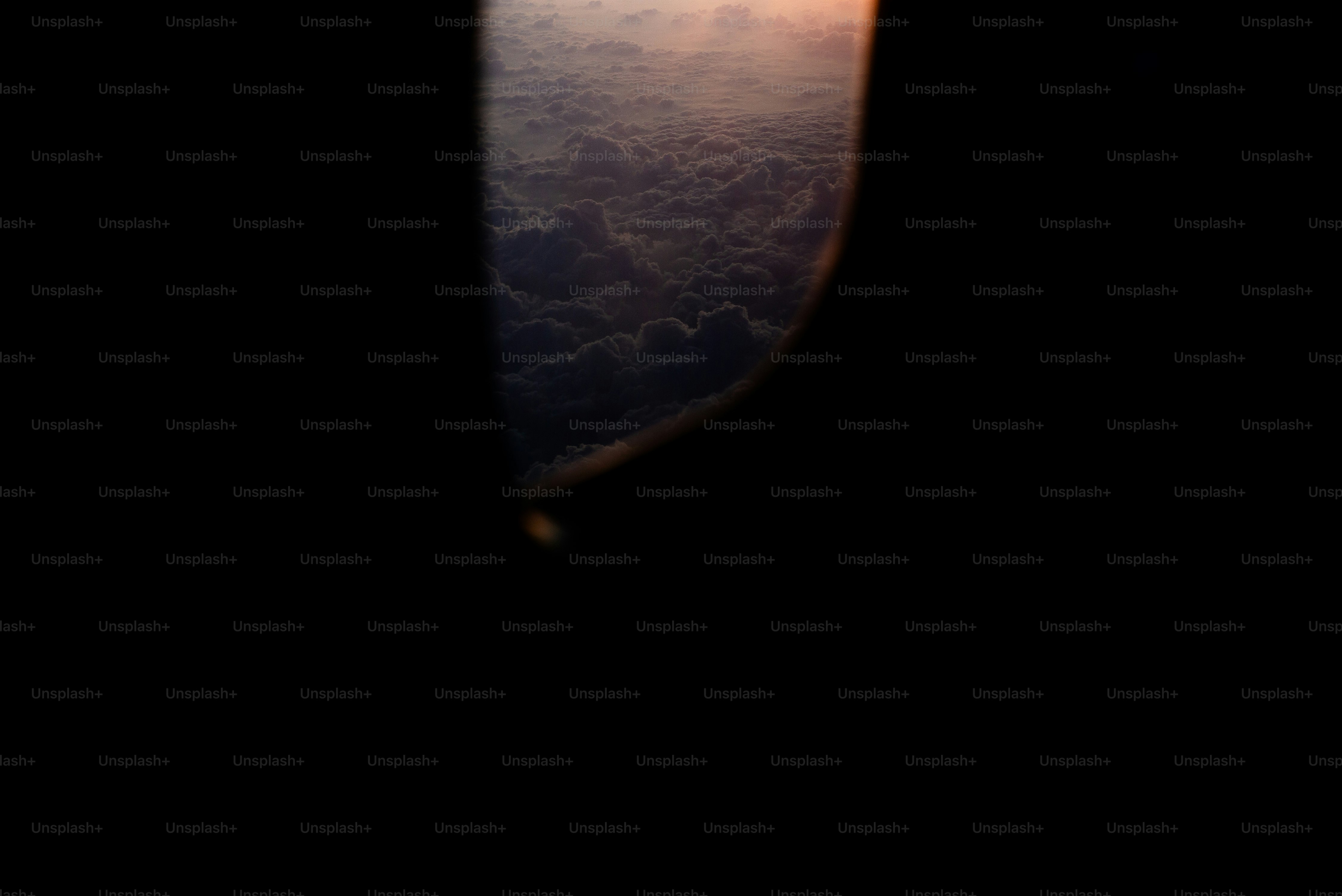 Clouds through airplane window - Photo on Unsplash+