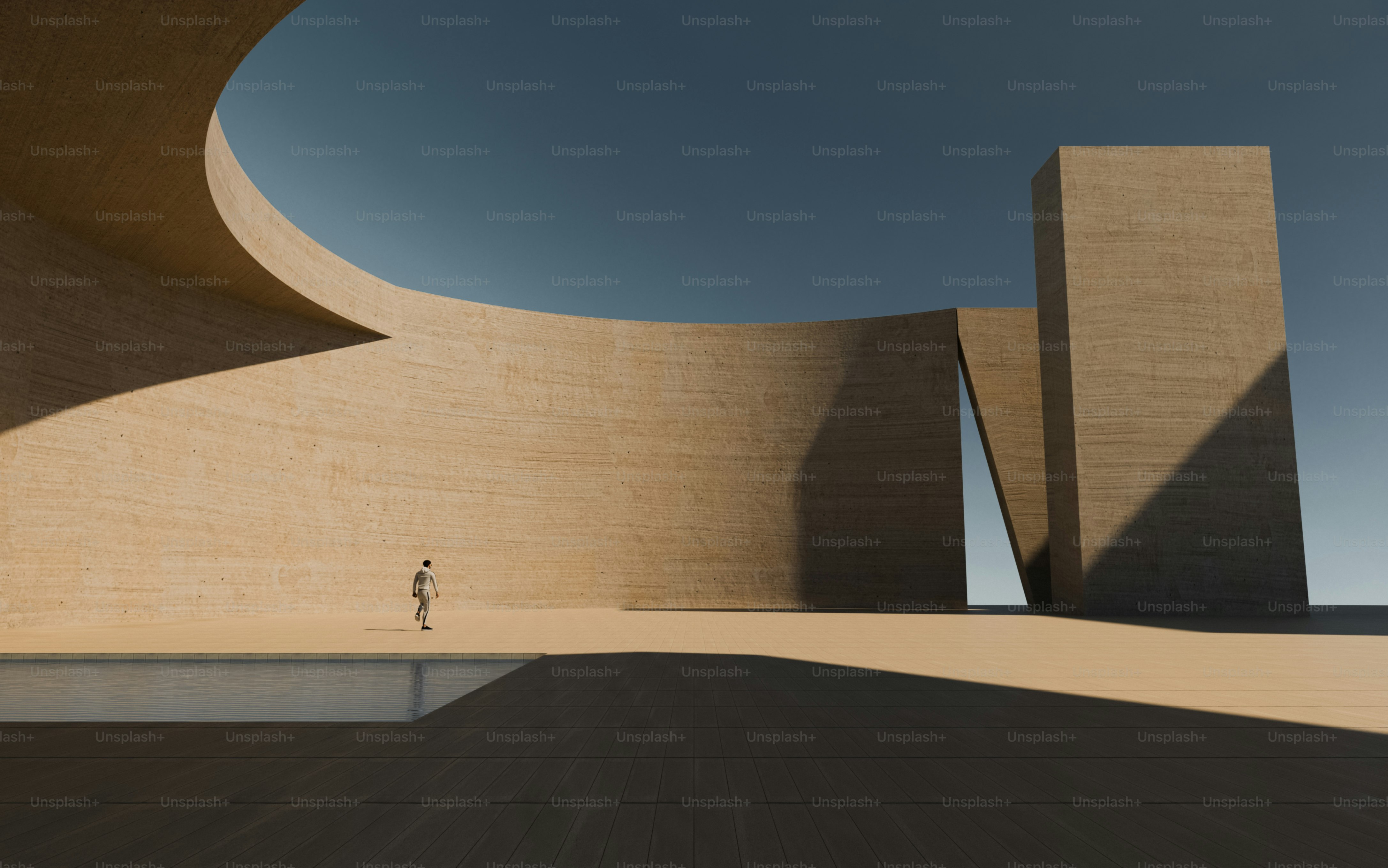 A person walking near a curved concrete wall and a rectangular pool