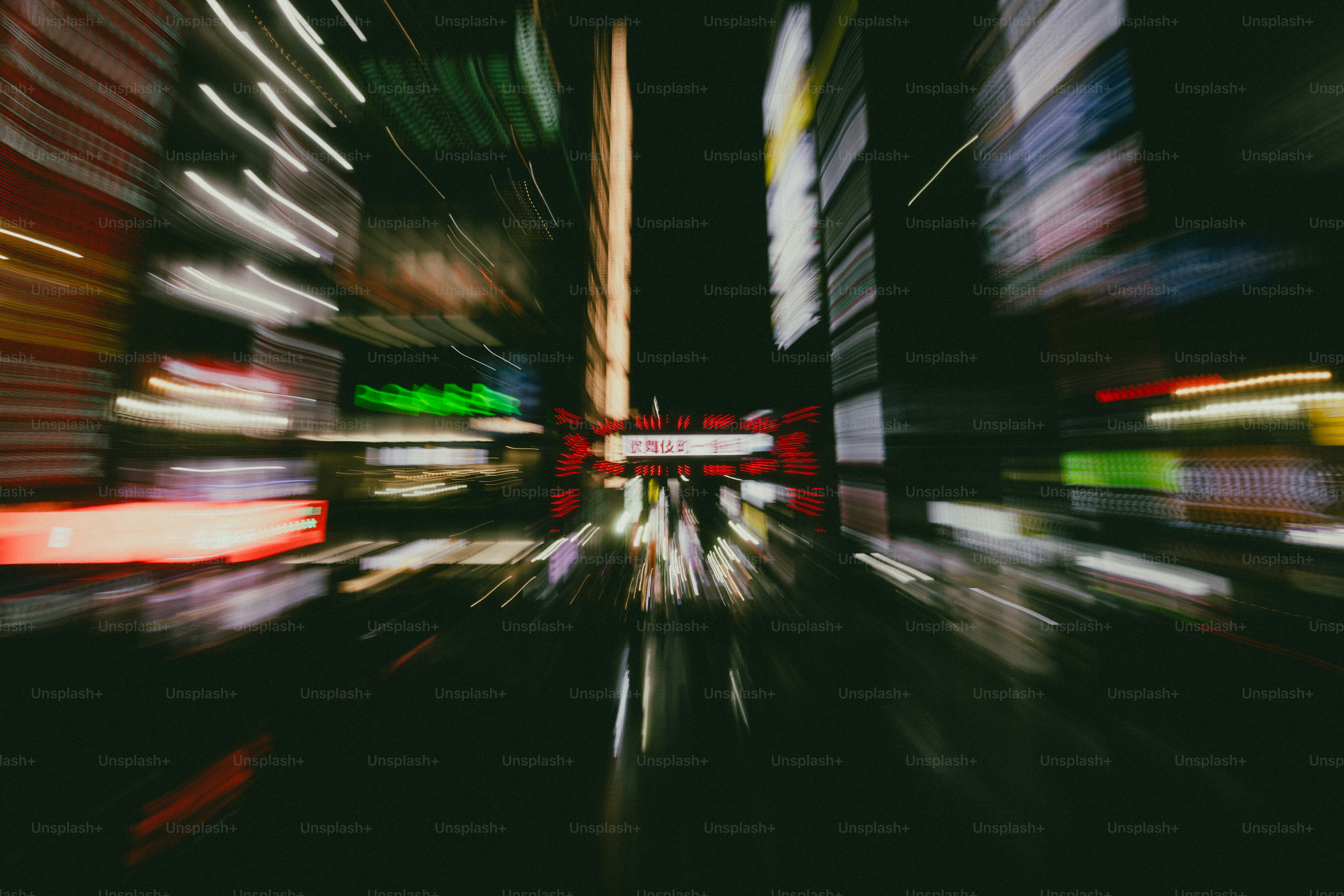 Motion blur of neon signs and city lights along a street in Shinjuku City