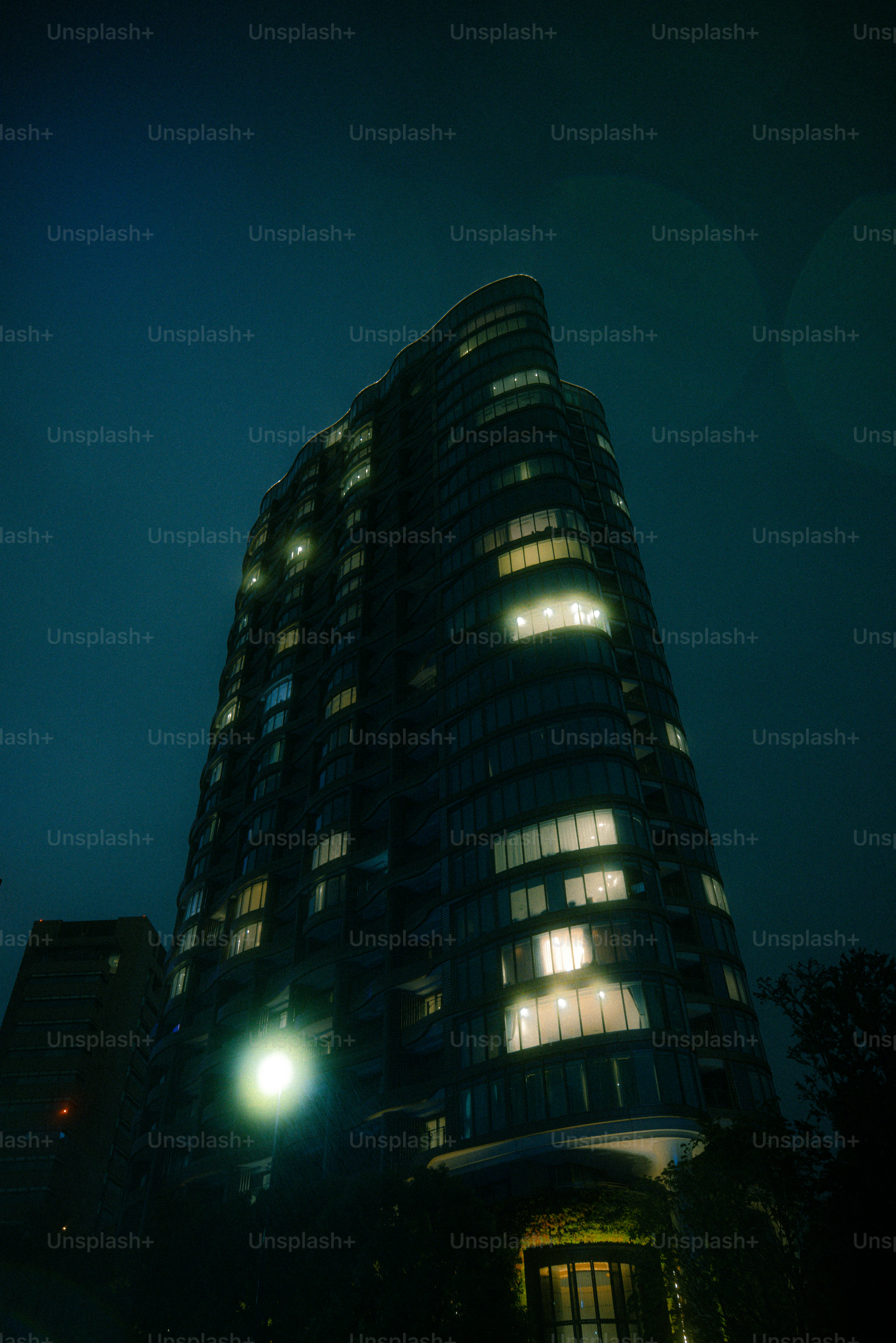 Modern apartment building at night - Photo on Unsplash+