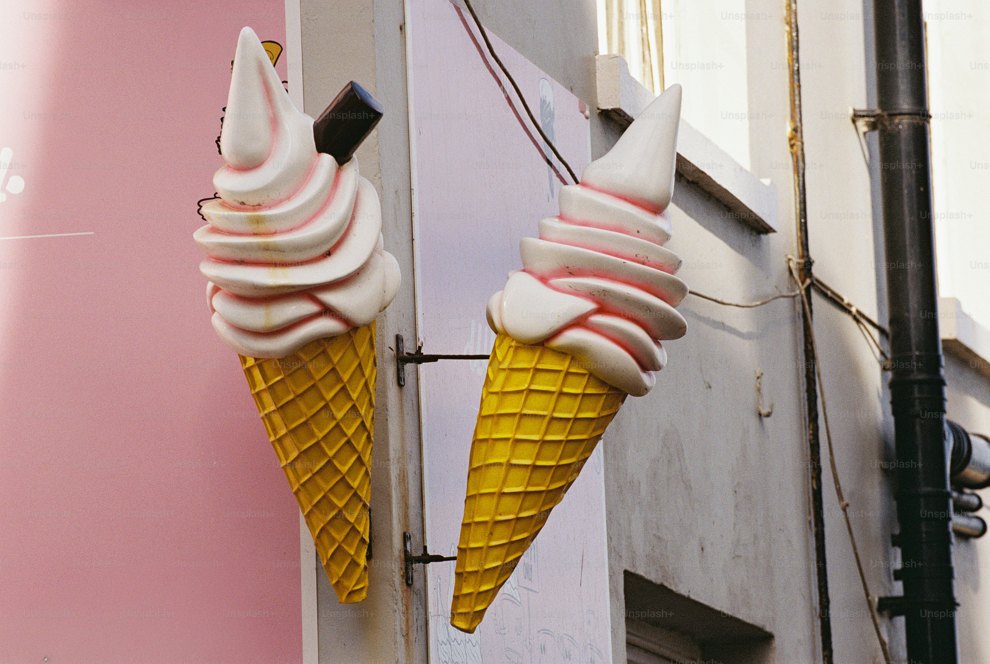 Ice cream cone sculptures on wall - Photo on Unsplash+