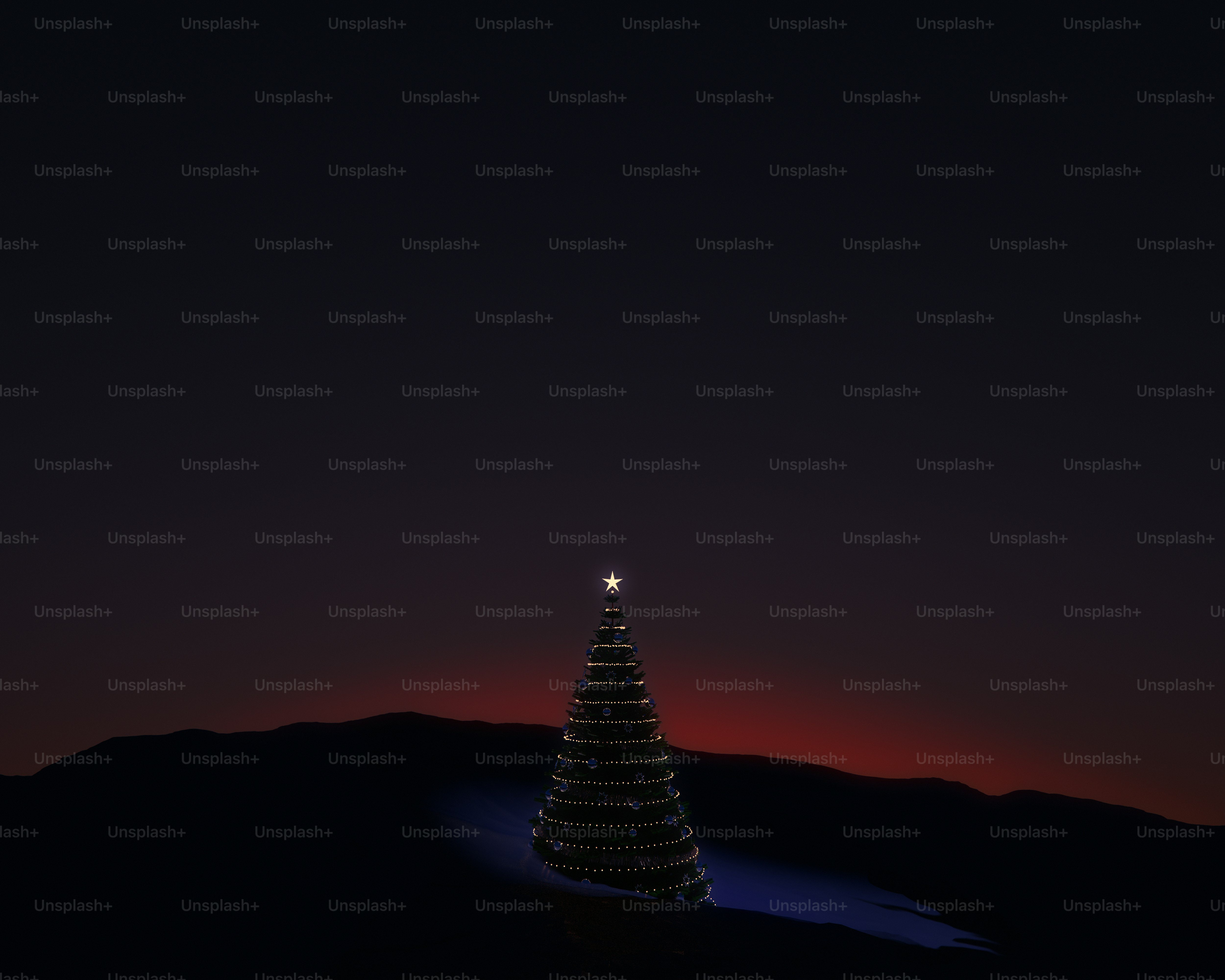 A lit Christmas tree with a star topper on a dark hillside at night