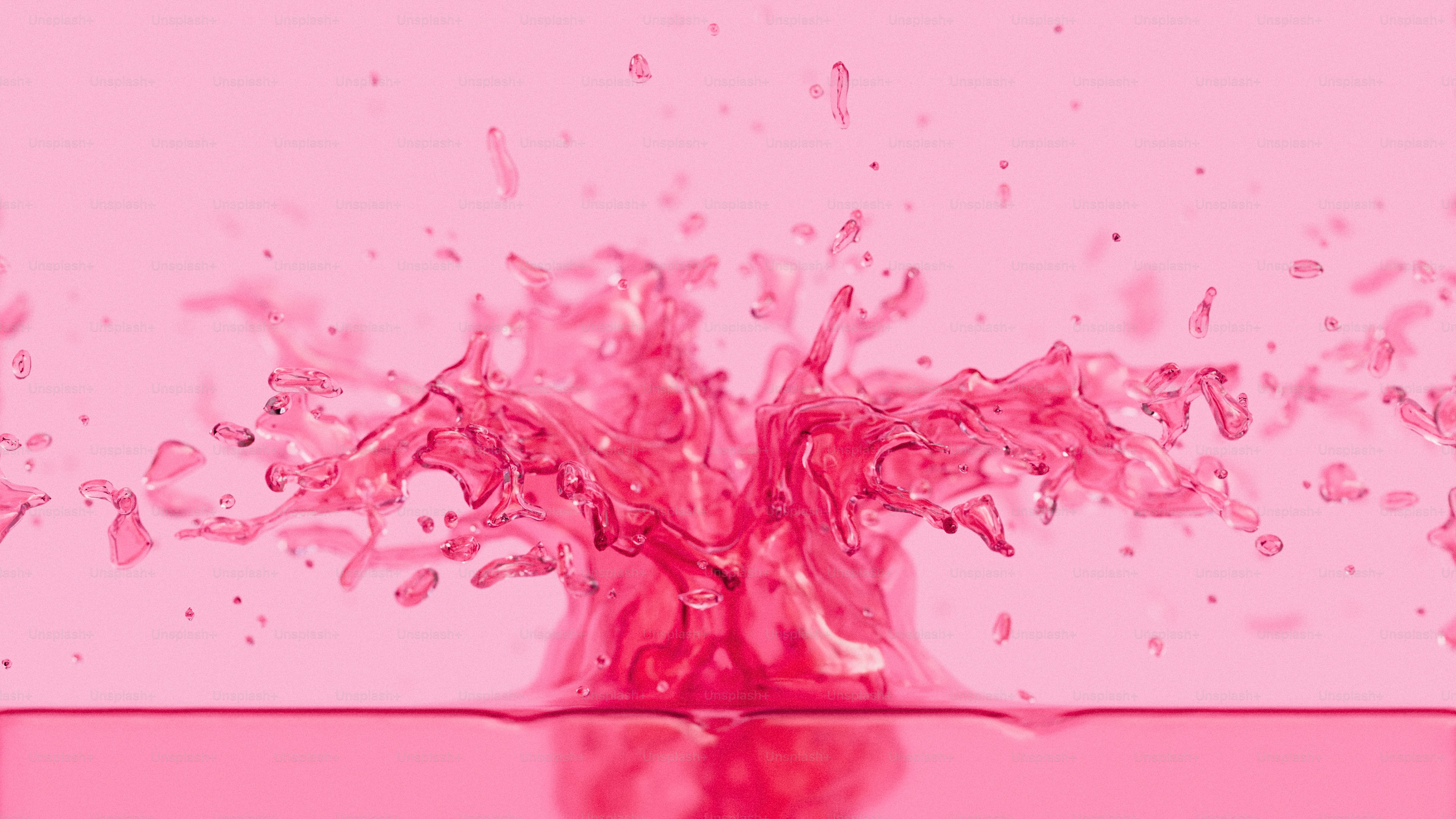 A 3D render of a pink liquid splashing upward against a matching pink background