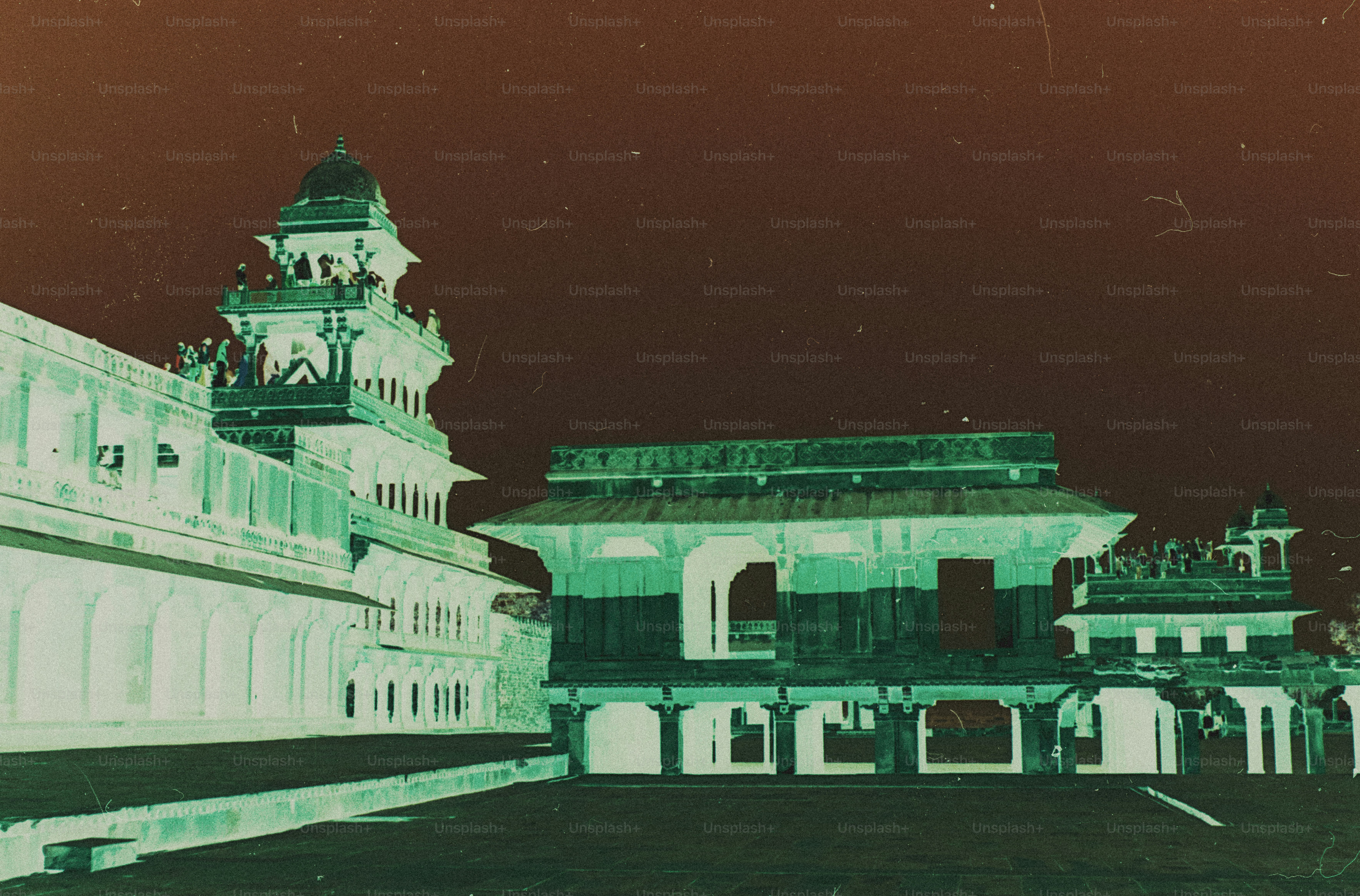 An inverted color view of the Panch Mahal palace in Fatehpur Sikri with people on the balconies