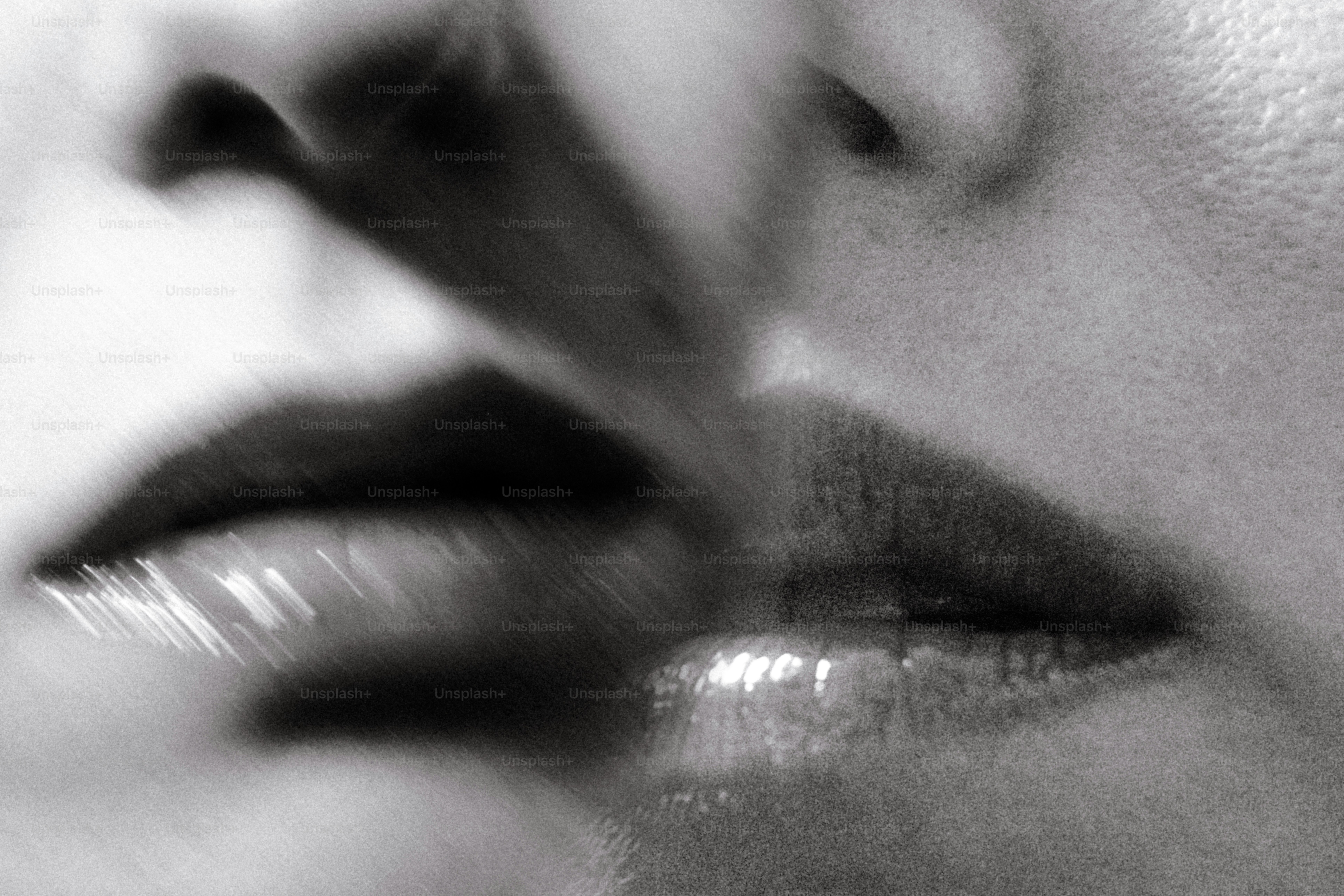 A close-up of lips in a black and white photograph with soft focus