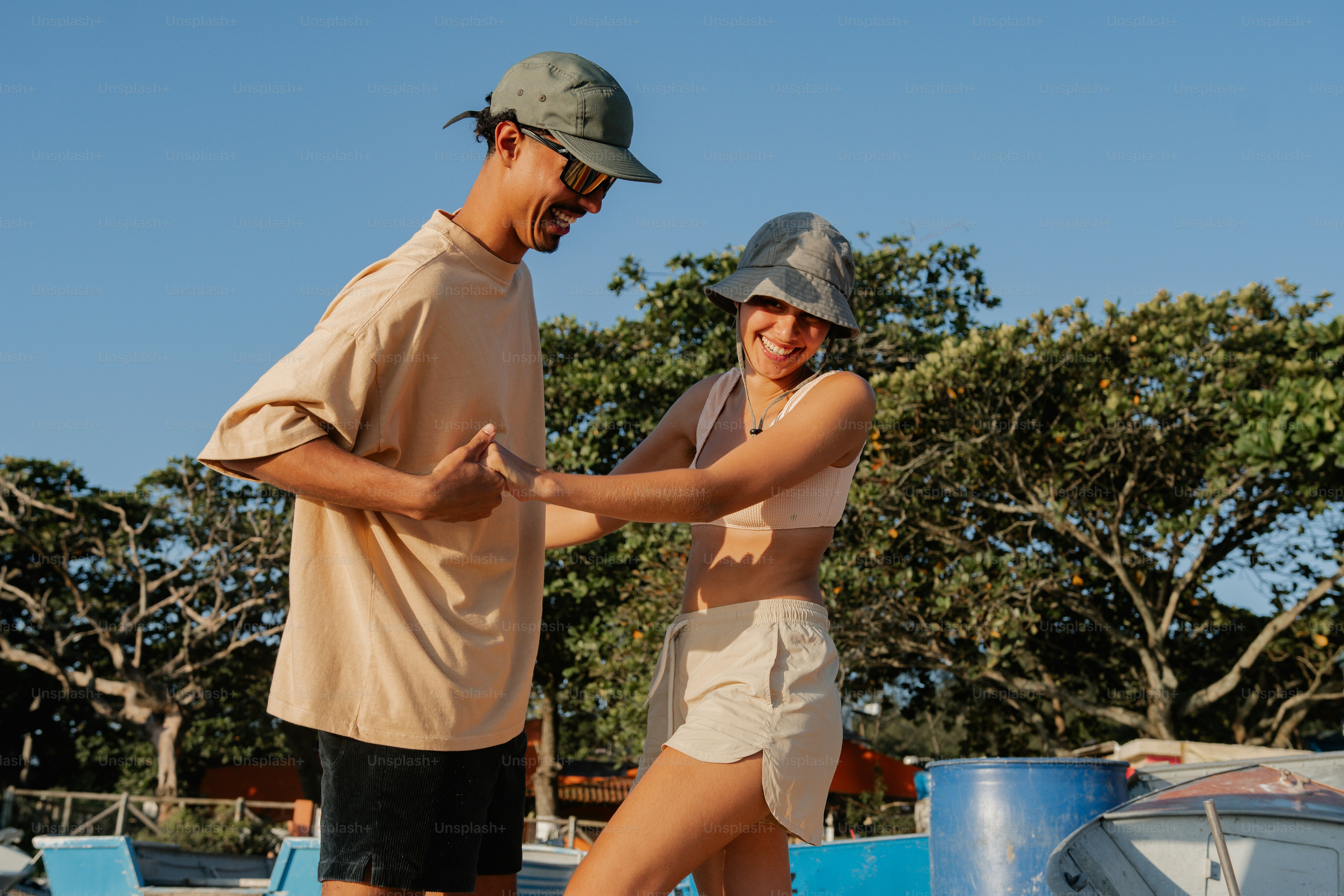 Man and woman holding hands on beach - Photo on Unsplash+
