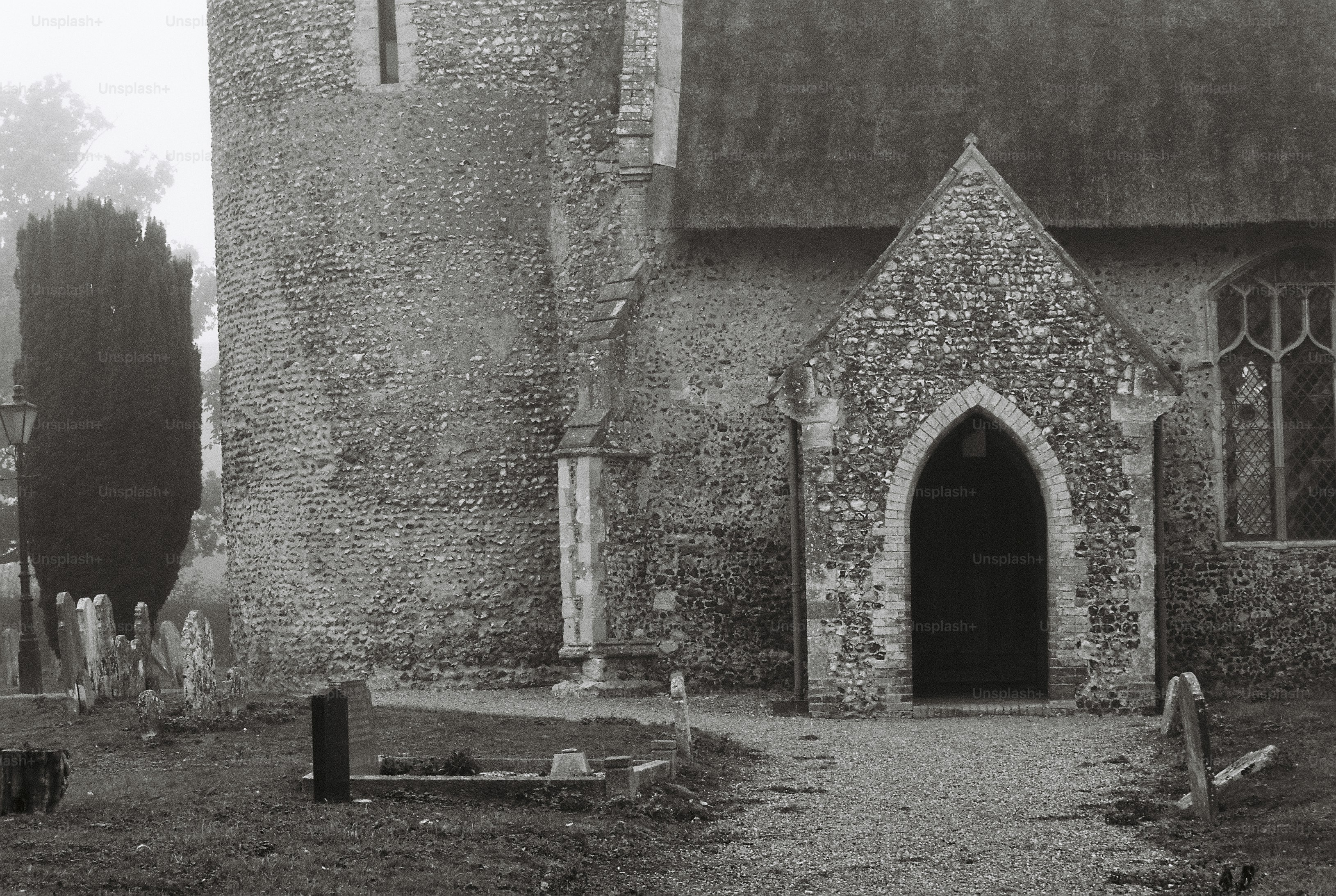 Flint porch and round stone tower - Photo on Unsplash+
