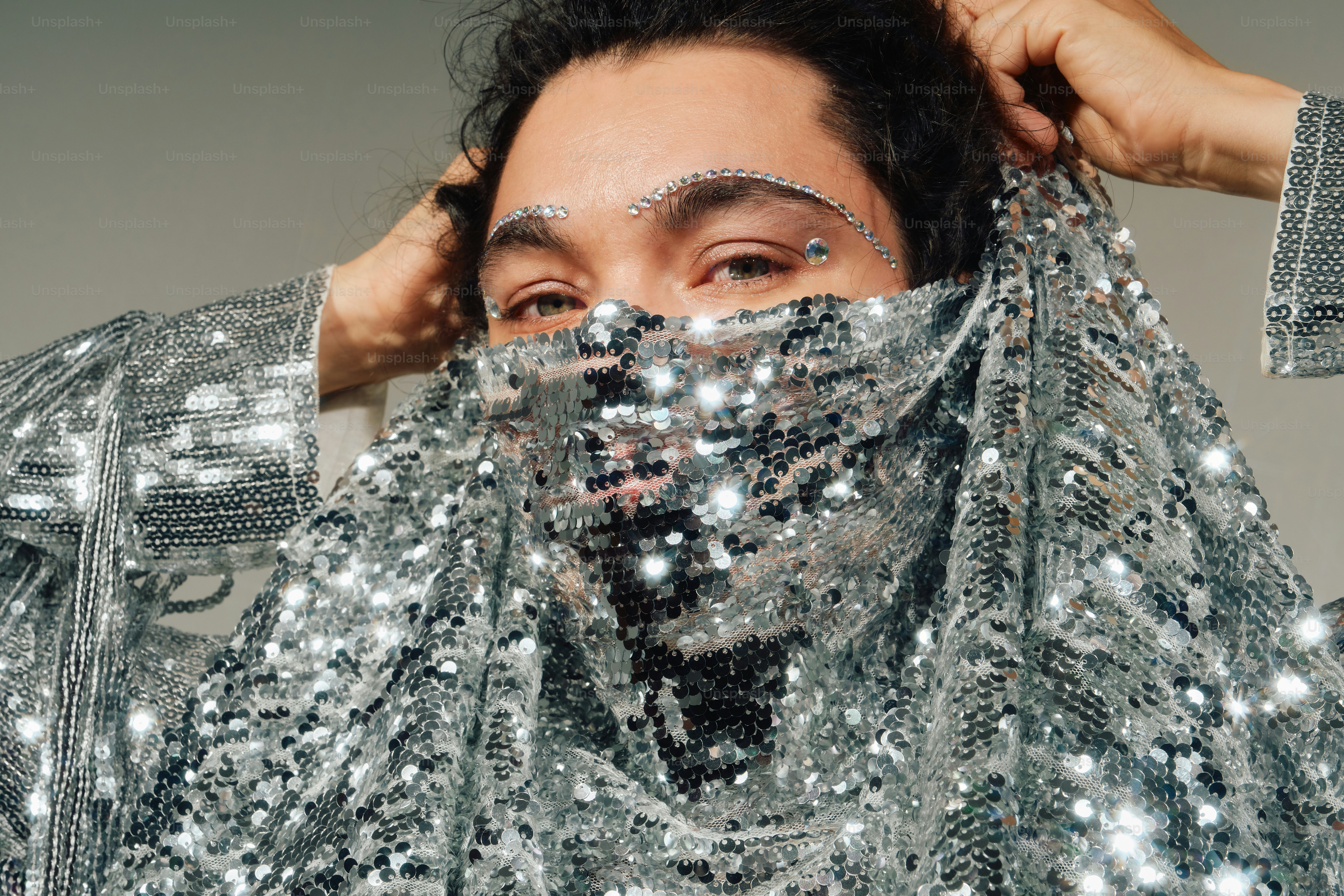 Person with rhinestone eyebrows and veil - Photo on Unsplash+